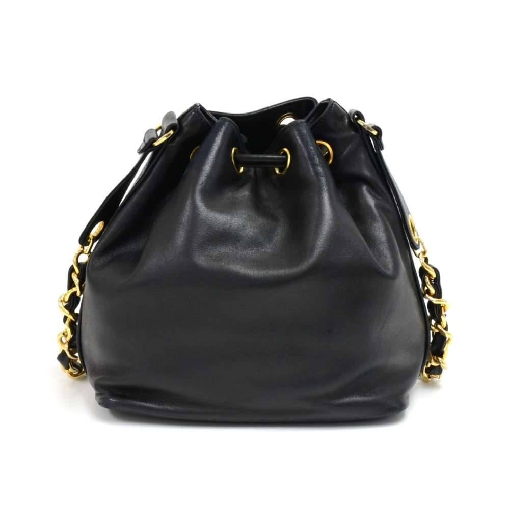 Vintage Chanel Black Lambskin Leather Drawstring Bucket Bag. A lovely bag with gold-tone hardware. The front has a large Chanel CC logo stitched on and has a drawstring closure with two gold-tone Chanel engraved ball charms to secure the bag. Inside