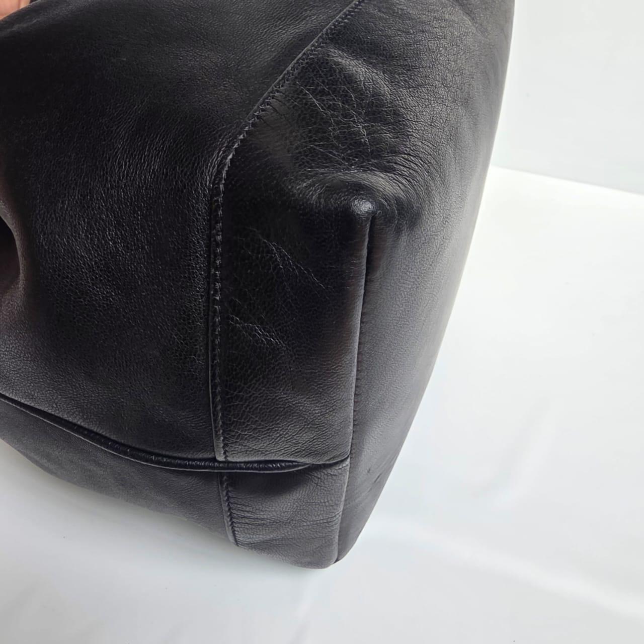 Classic Chanel vintage black lambskin bucket bag. Good vintage condition with scuffs and scratches. Blurred holo. Comes with replacement chanel dust bag.
