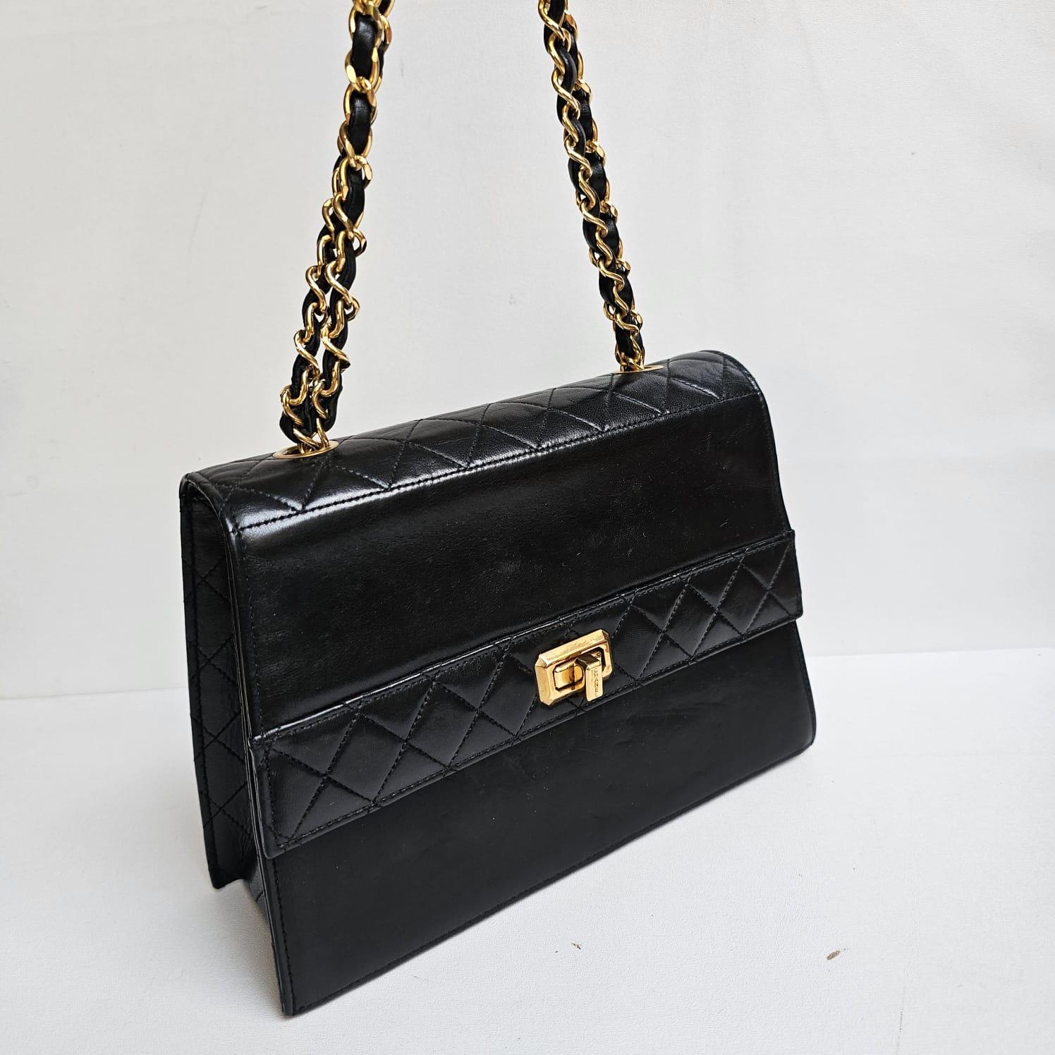 Beautiful trapezoid vintage shoulder bag in black lambskin leather. Overall in good condition, with faint nail marks and scratches. Minor touch ups has been done to lightly cover the marks. Comes with the small wallet. Series #1. Holo has darkened