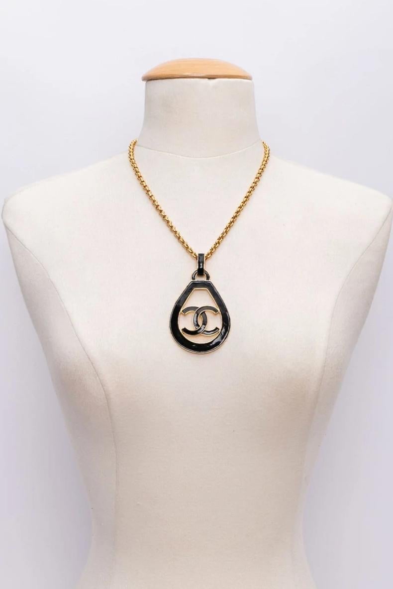 From the 1993 Croisière ( cruise) collection. Gilded metal. Black enamel on pendant.
 Signature in the back.
Effortlessly chic!
Pendant is 3.2”x2”