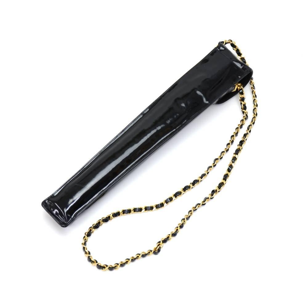 Vintage Chanel black nylon Umbrella with a black patent leather case. The umbrella has a leather handle and wrist strap and lovely gold-tone hardware. It is secured with the classic Chanel twist lock. The patent leather case is secured with the CC