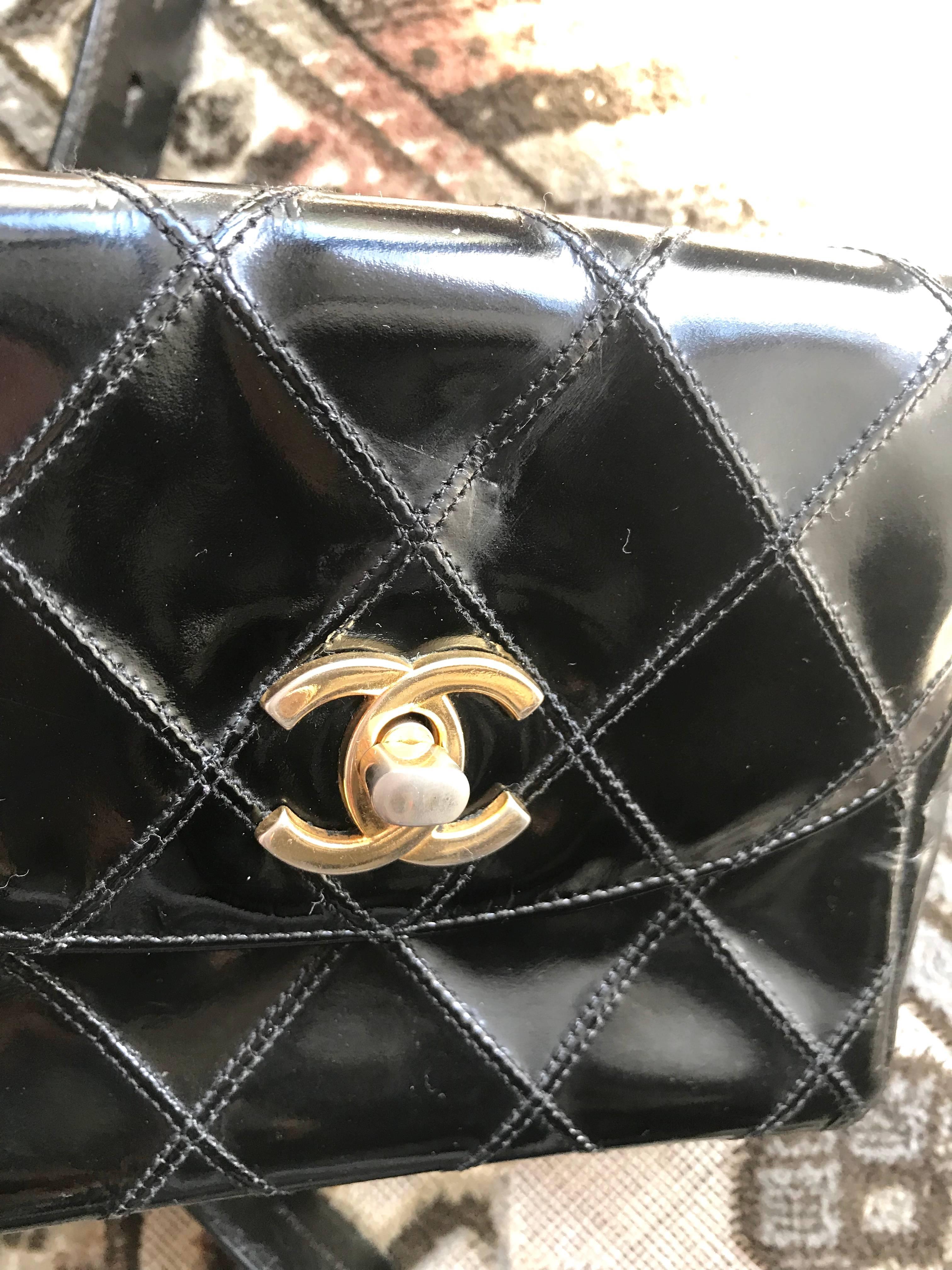 Black Vintage CHANEL black patent enamel pouch, fanny pack with CC and aurora belt. 