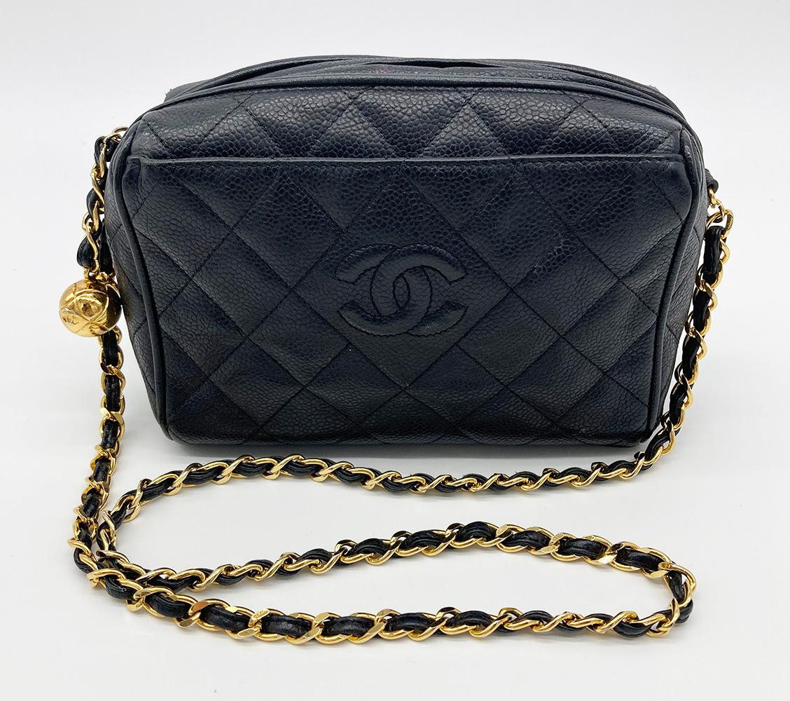 Vintage Chanel Black Quilted Caviar Camera Bag in excellent condition. Black quilted caviar leather with quilted CC logo along front, gold hardware and woven chain and leather shoulder strap. Front exterior slit pocket. Top zip closure with gold