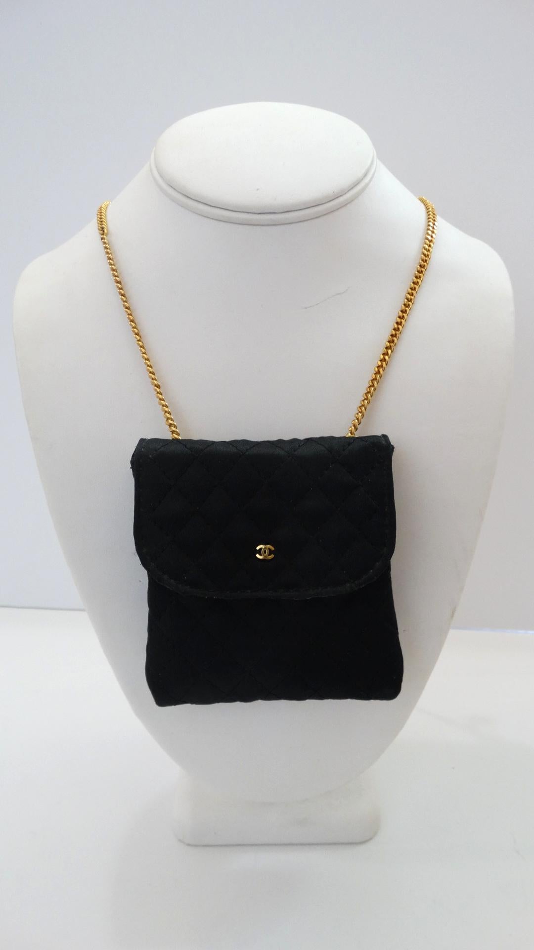 Mini bags are so en vogue! Rock the tiny-pouch trend seen all over the runways this past season with our vintage Chanel satin necklace bag! Constructed from black satin with Chanel's signature quilted stitching. Miniature gold 