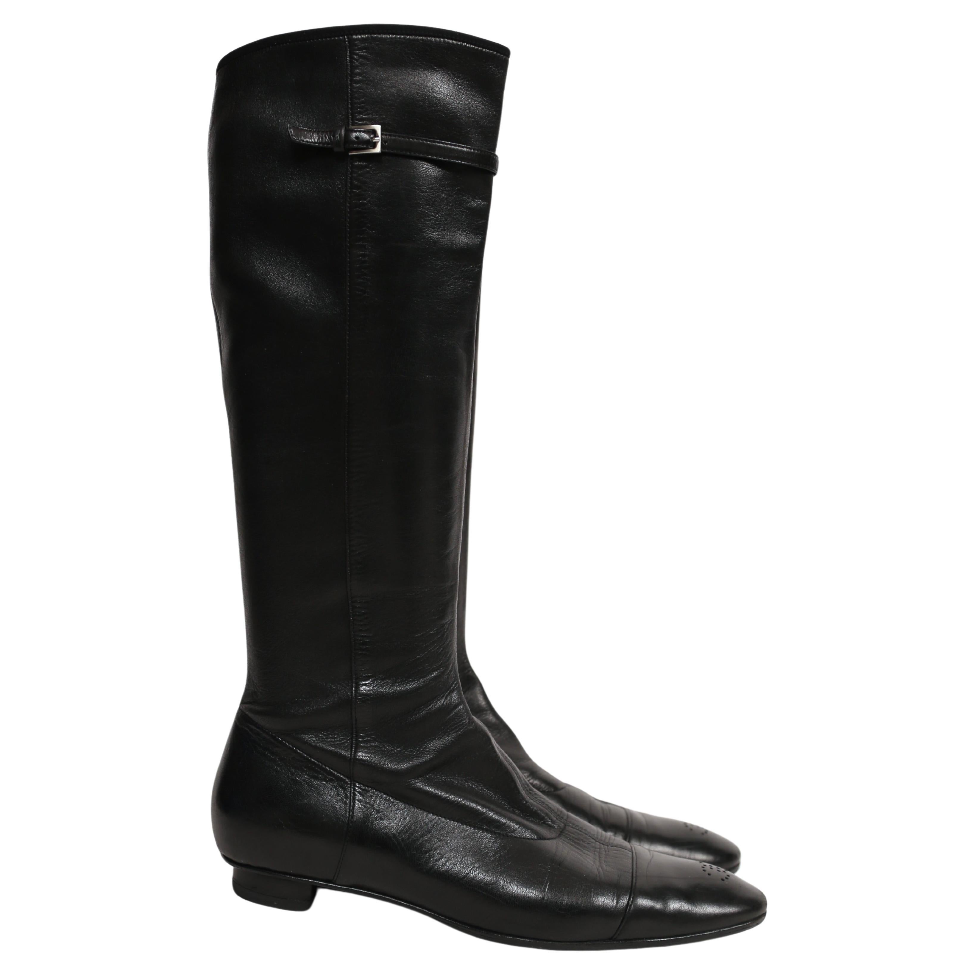 Black stretch leather boots with CC detail at toes designed by Chanel dating to the late 1990's, early 2000's. French Size 39.5 (US 9-9.5).  Composed entirely of leather. Pull on entry. Protective soles were added. Made in Italy. Good condition.

