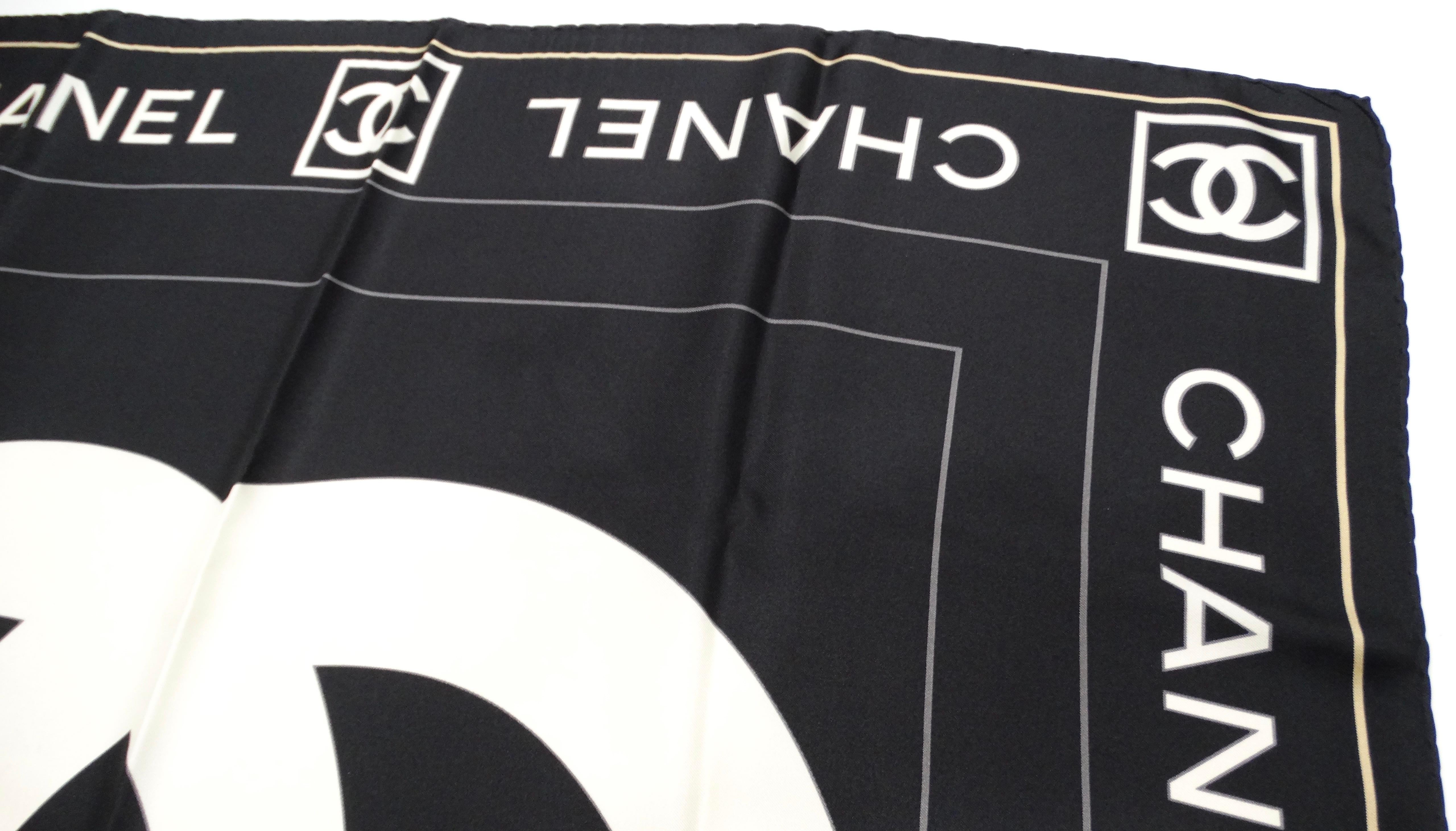 The Vintage Chanel Black & White Silk Interlocking CC Logo Scarf is a timeless piece that embodies the elegance and sophistication associated with the Chanel brand. Crafted from luxurious silk, this exquisite scarf features the iconic interlocking