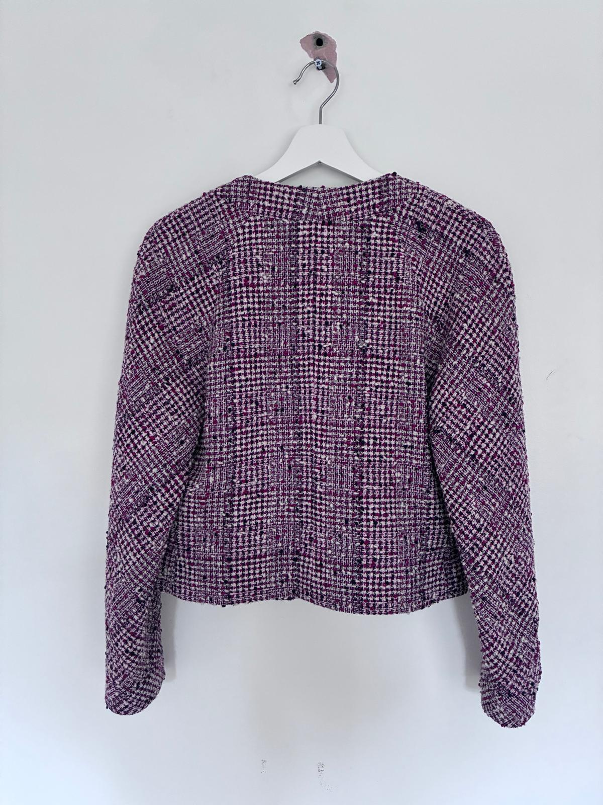 Vintage tweed skirt and jacket from Chanel Boutique label. Shades of red, navy and white in a textured tweed pattern. Jacket is cropped blouson style and is double breasted with 8 front buttons. Wide round neckline. Sleeves slightly dropped. Two