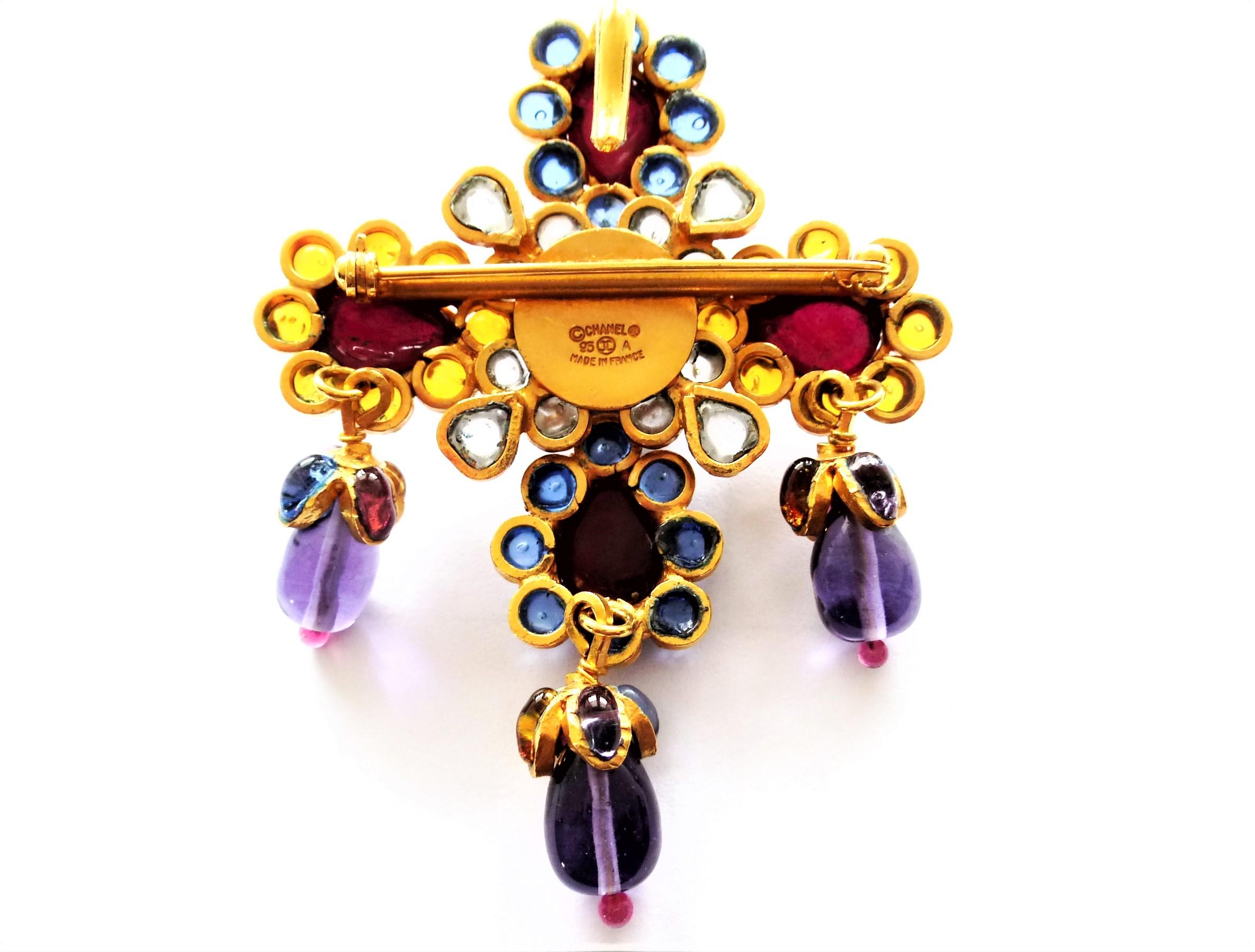 A wonderful Chanel brooch, also to wear as a pendant, from Gripoix. The metal work of Robert Goossens Paris and each blossom and the drops are filled with liquid glass in blue, yellow, purple, red and clear from the Maison of Gripoix. The brooch is