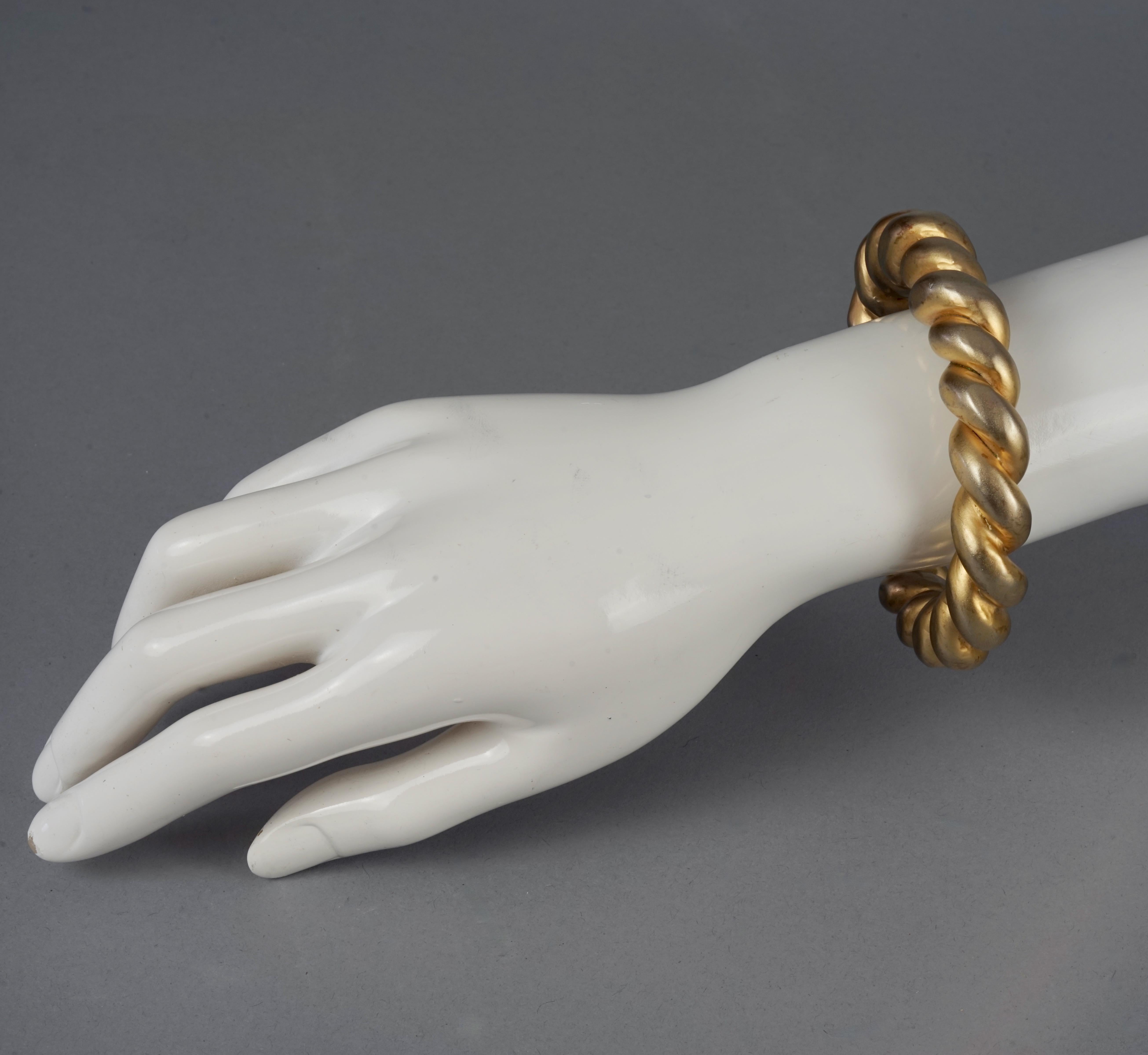 Vintage CHANEL by VICTOIRE de CASTELLANE Twisted Rope Bangle Bracelet

Measurements:
Thickness: 0.59 inch (1.5 cm)
Inner Circumference: 7.48 inches (19 cm)

Features:
- 100% Authentic CHANEL by VICTOIRE de CASTELLANE
- Twisted cord in cold cast