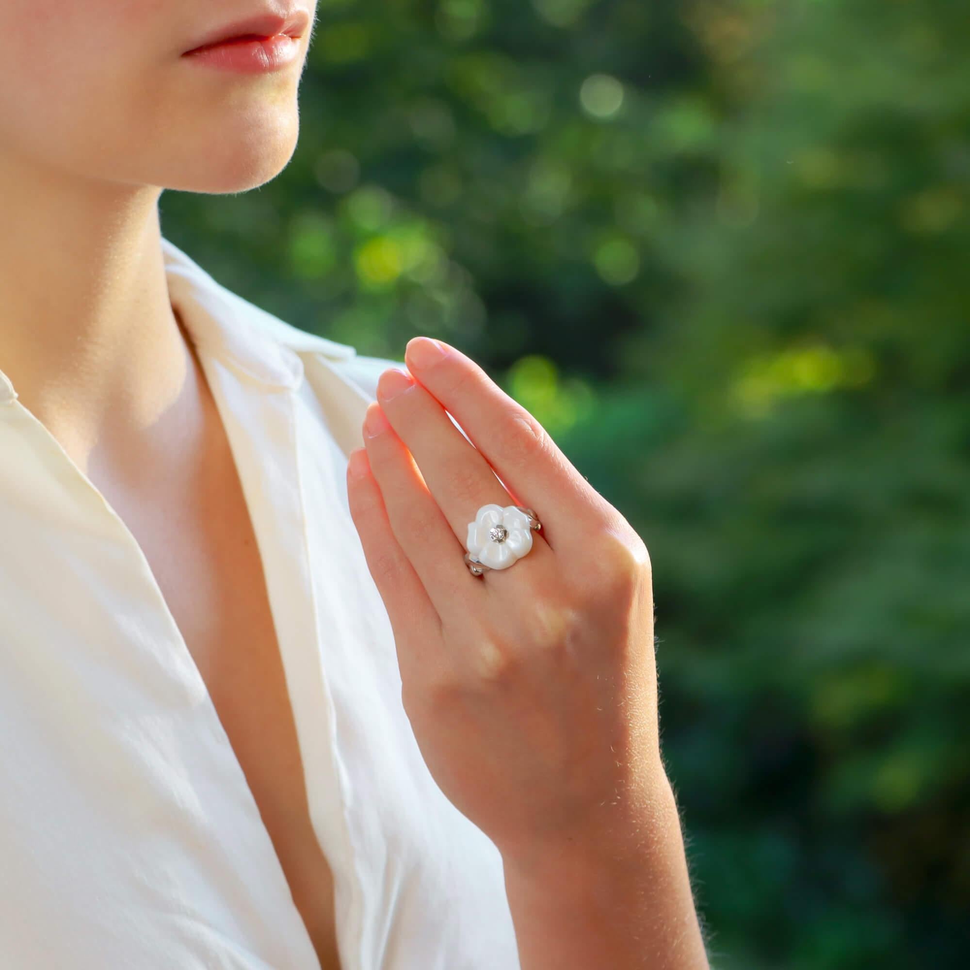 An extremely elegant vintage Chanel white ceramic and Diamond flower ring set in 18k white gold.

From the Camélia Galbé collection, this ring is predominantly composed of a white ceramic flower motif. Set to the centre of this flower is intricate