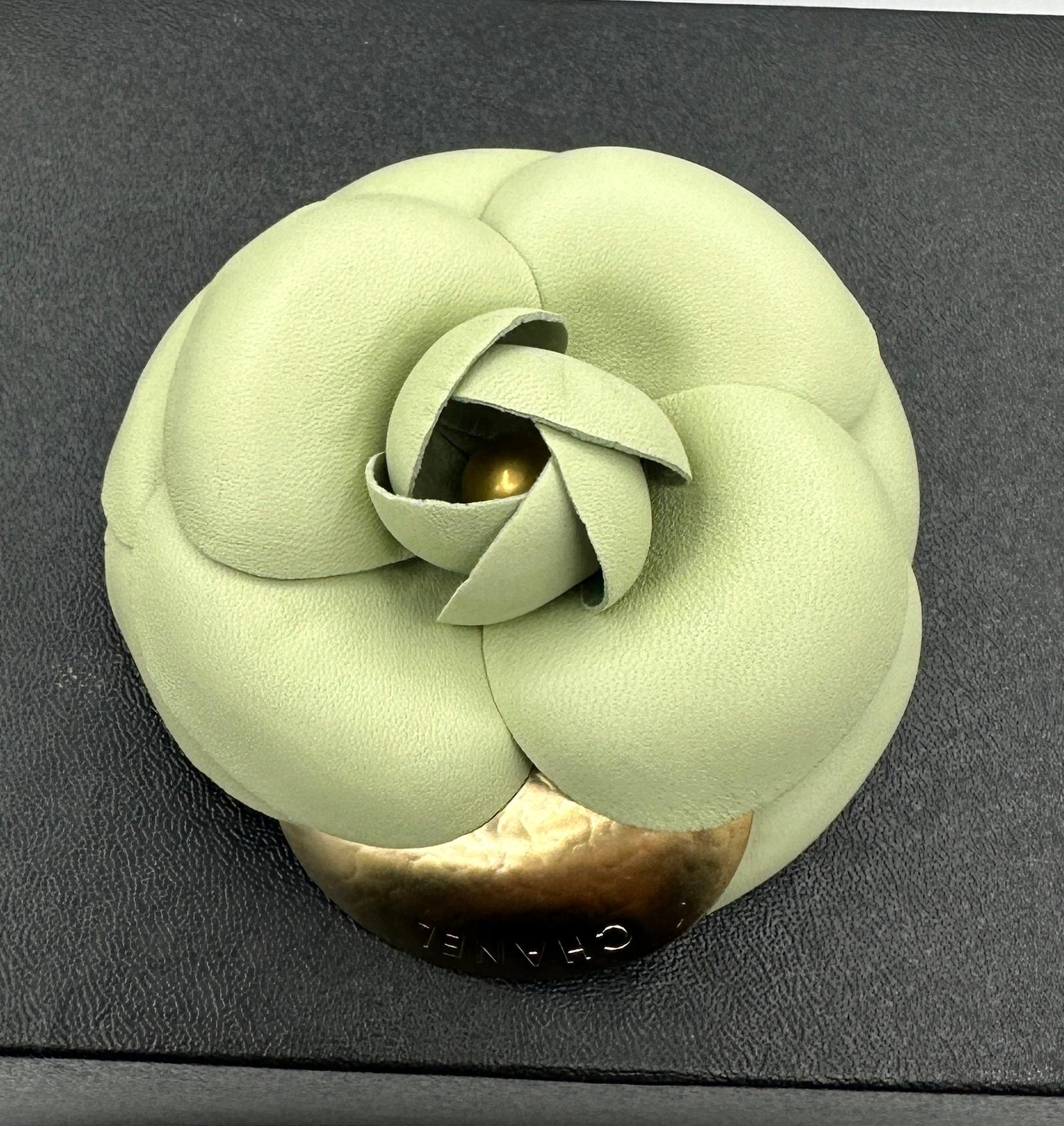 This is a fabulous vintage Chanel Caméllia Flower brooch in pale Seafoam Green Leather with a single gold CHANEL petal.   It is an elegant vintage brooch by the House of Chanel in a very rare and wonderful pale green color.  The rare Camellia Flower