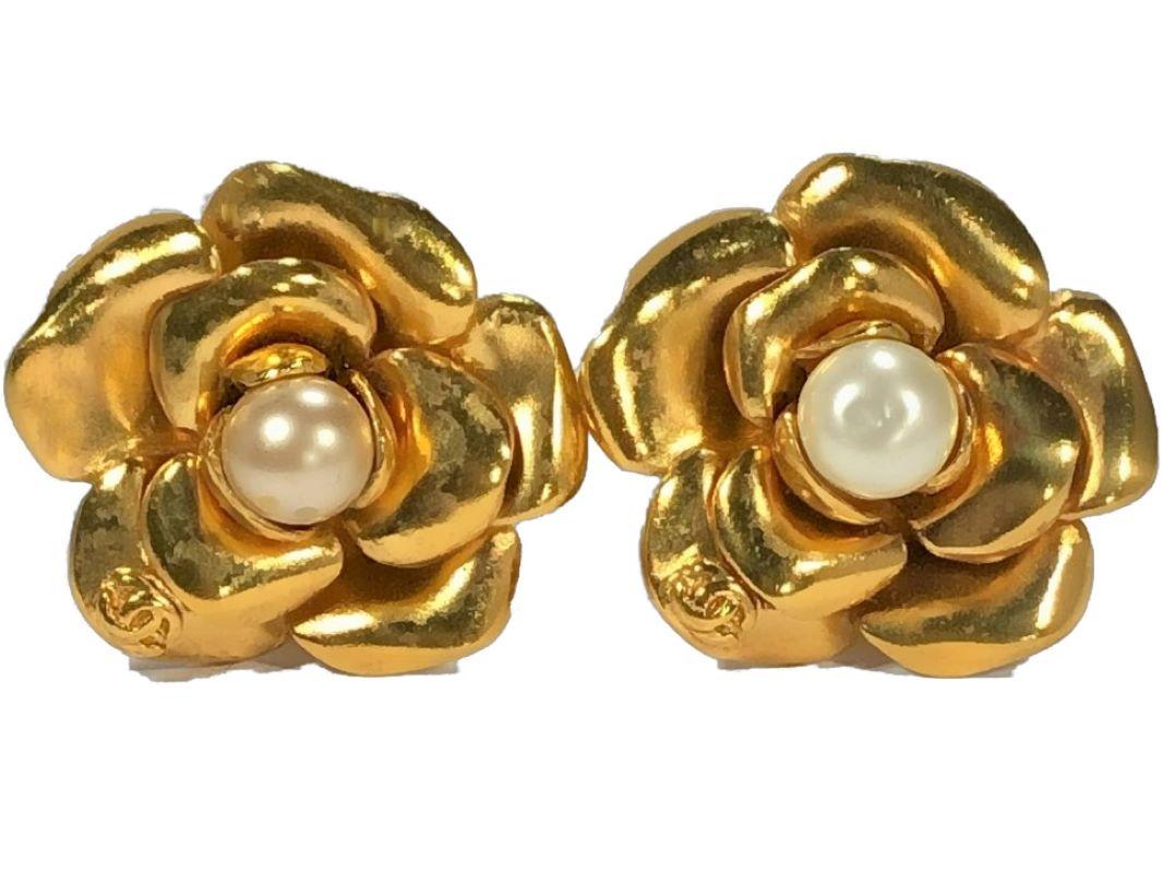 These wonderful gold tone vintage Chanel camellia earrings have faux pearl centers and the CC logo on one of the flower petals. The clip on backs are nice and firm. Signed CHANEL MADE IN FRANCE with the CC Logo and marked 99P,  indicating these are