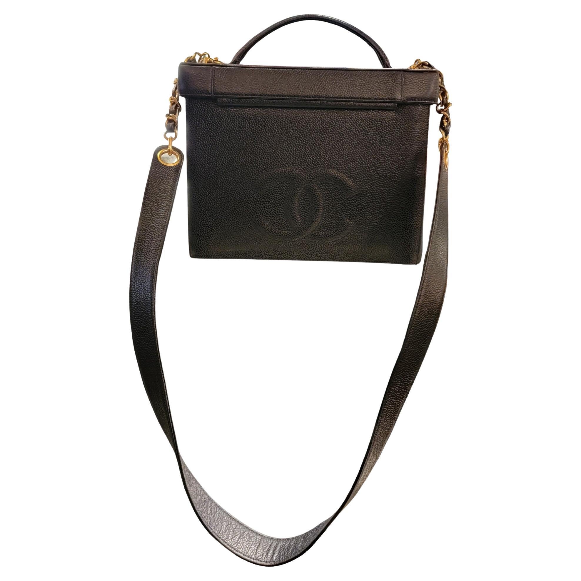 Chanel 2 way CC hand and shoulder bag that opens up with a mirror underneath the cover. The  leather has a large Golden CC buckle in front and a large leather CC in back. The straps are made from the same caviar leather and gold accents. 
The