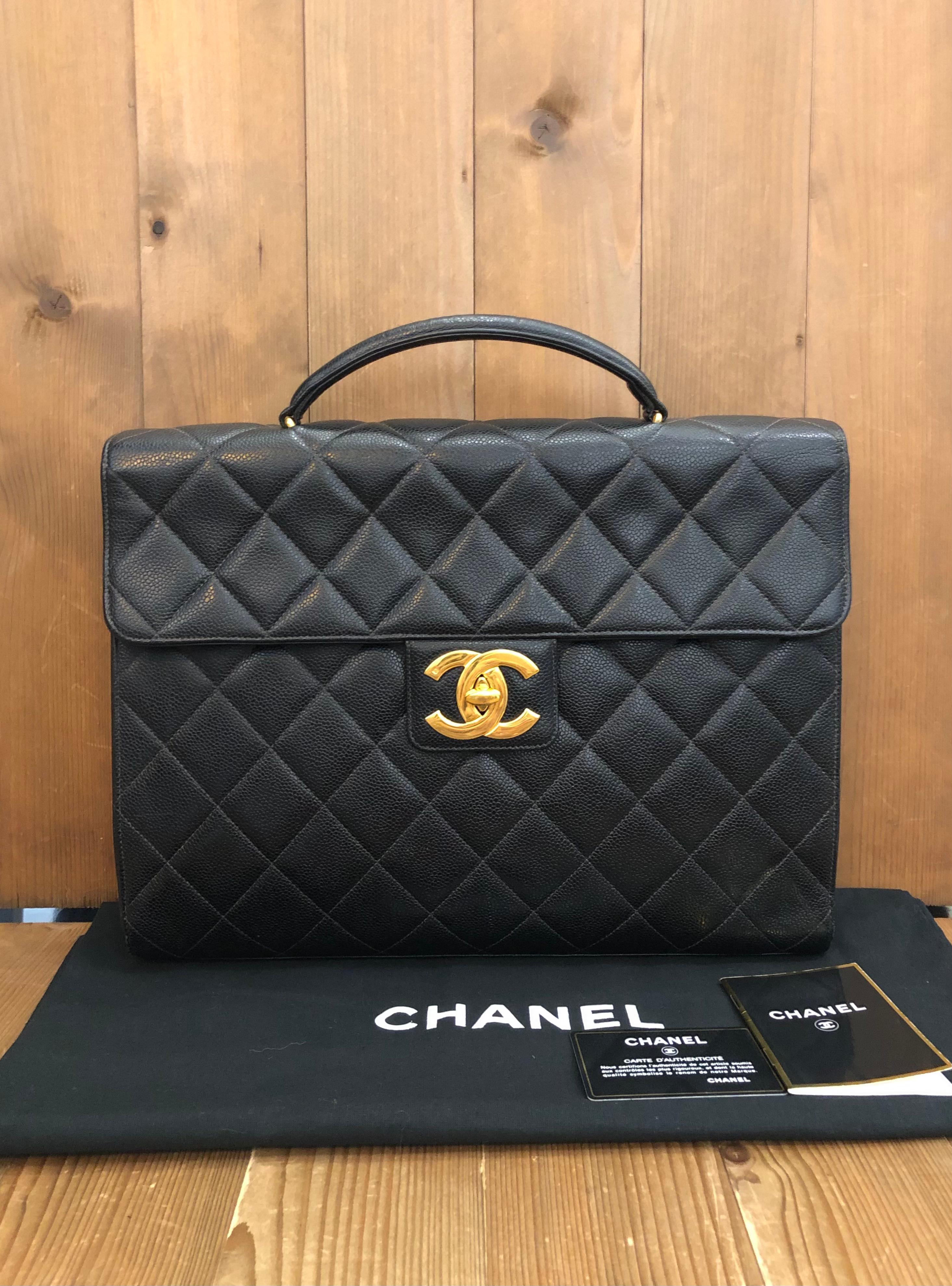 This vintage CHANEL jumbo logo briefcase is crafted of caviar calfskin leather in black and gold toned hardware. Frontal oversized 24K gold plated CC turnlock opens to a black leather interior featuring patch and zippered pockets. This briefcase