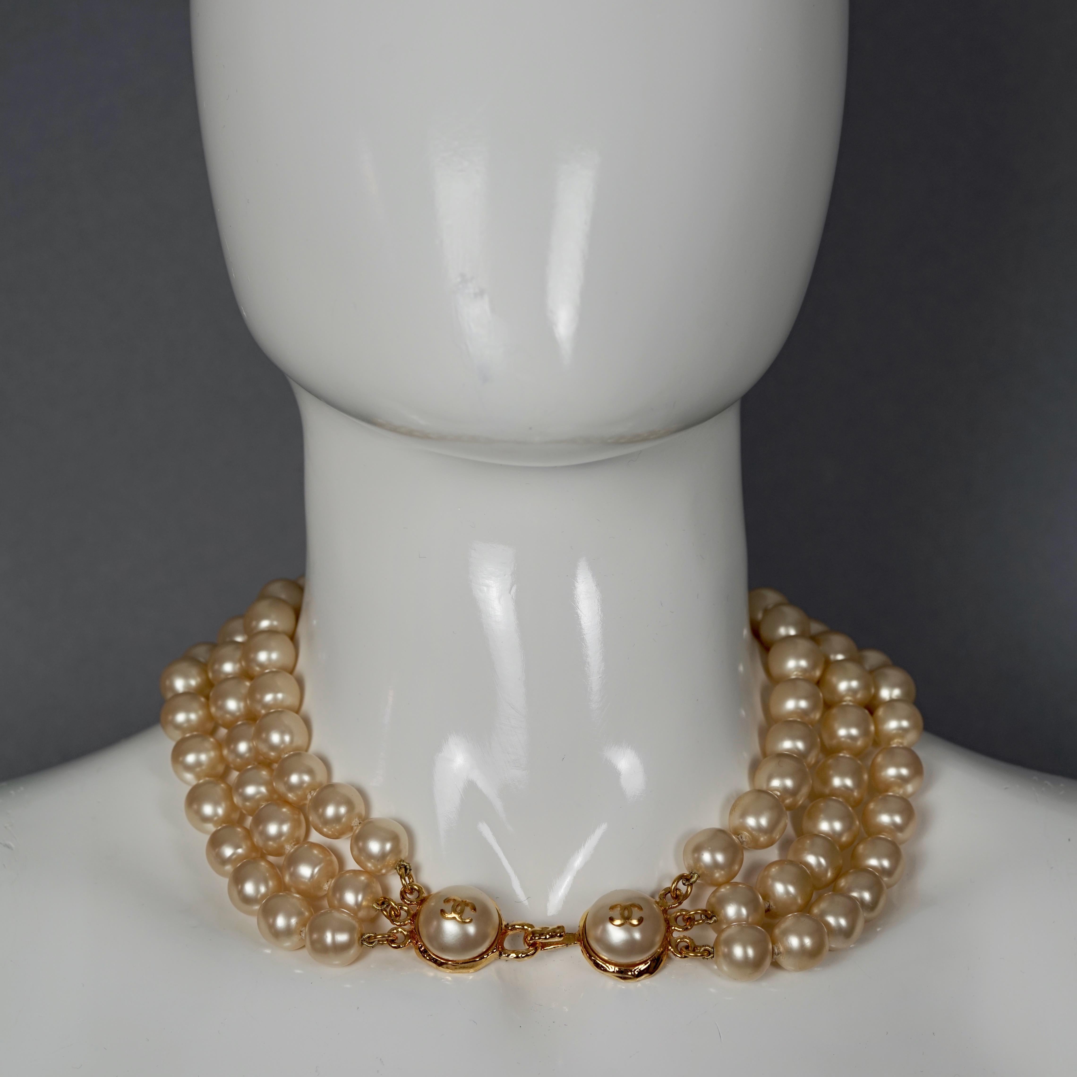 Vintage CHANEL CC Logo Triple Strand Pearl Necklace

Measurements:
Drop Height: 2.75 inches  (7 cm)
Pearl Diameter: 0.47 inch (1.2 cm)
Wearable Length: 16.53 inches (42 cm)

Features:
- 100% Authentic CHANEL.
- Triple strand pearl necklace with CC