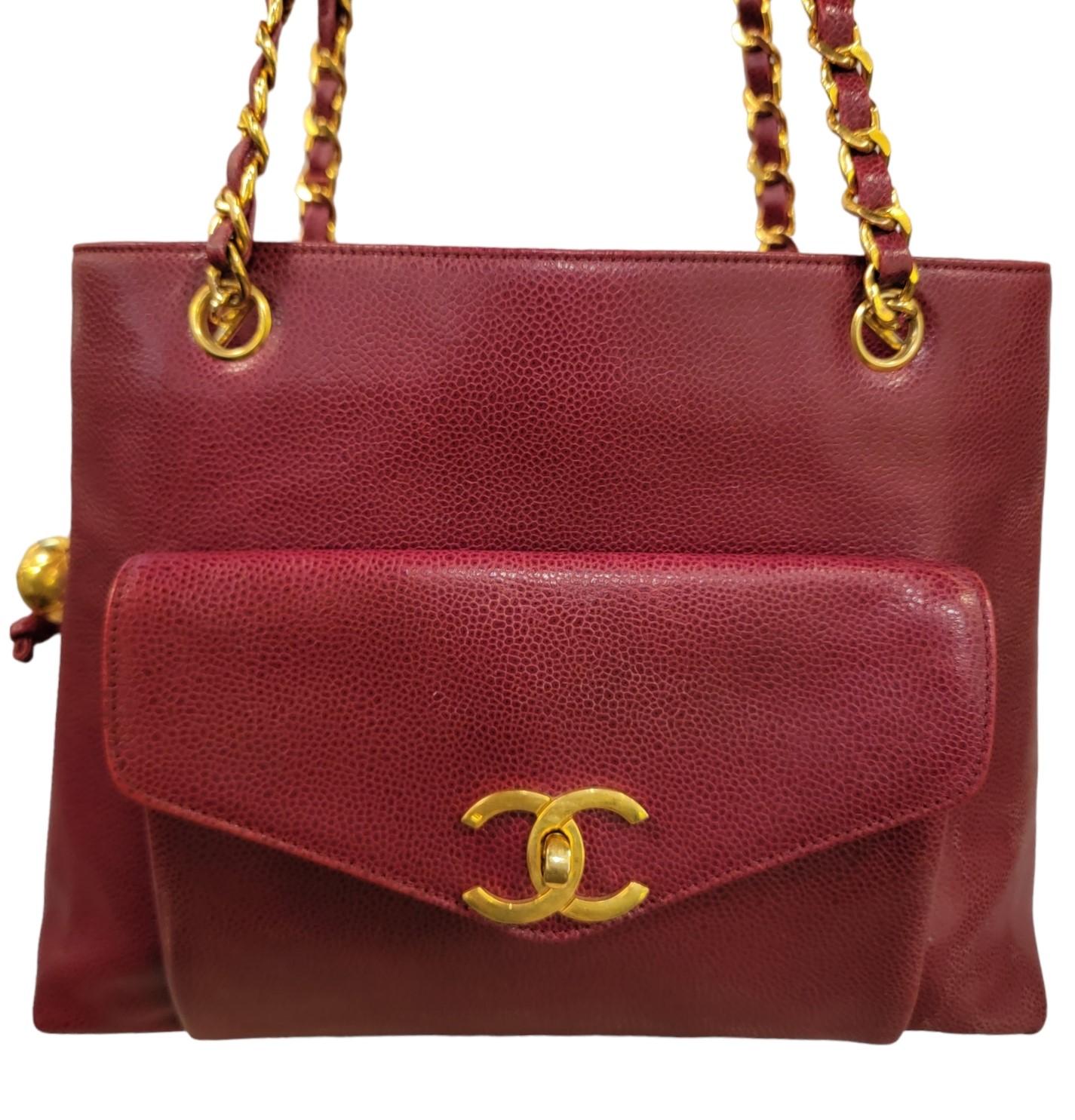 Vintage Chanel CC Rare Caviar Leather Shoulder. 

Chanel CC Rare Caviar Leather Shoulder. Winderful red caviar leather with gold accents. CC buckle in the front pocket gold and leather shoulder straps. This bag has 3 larger compartments within the