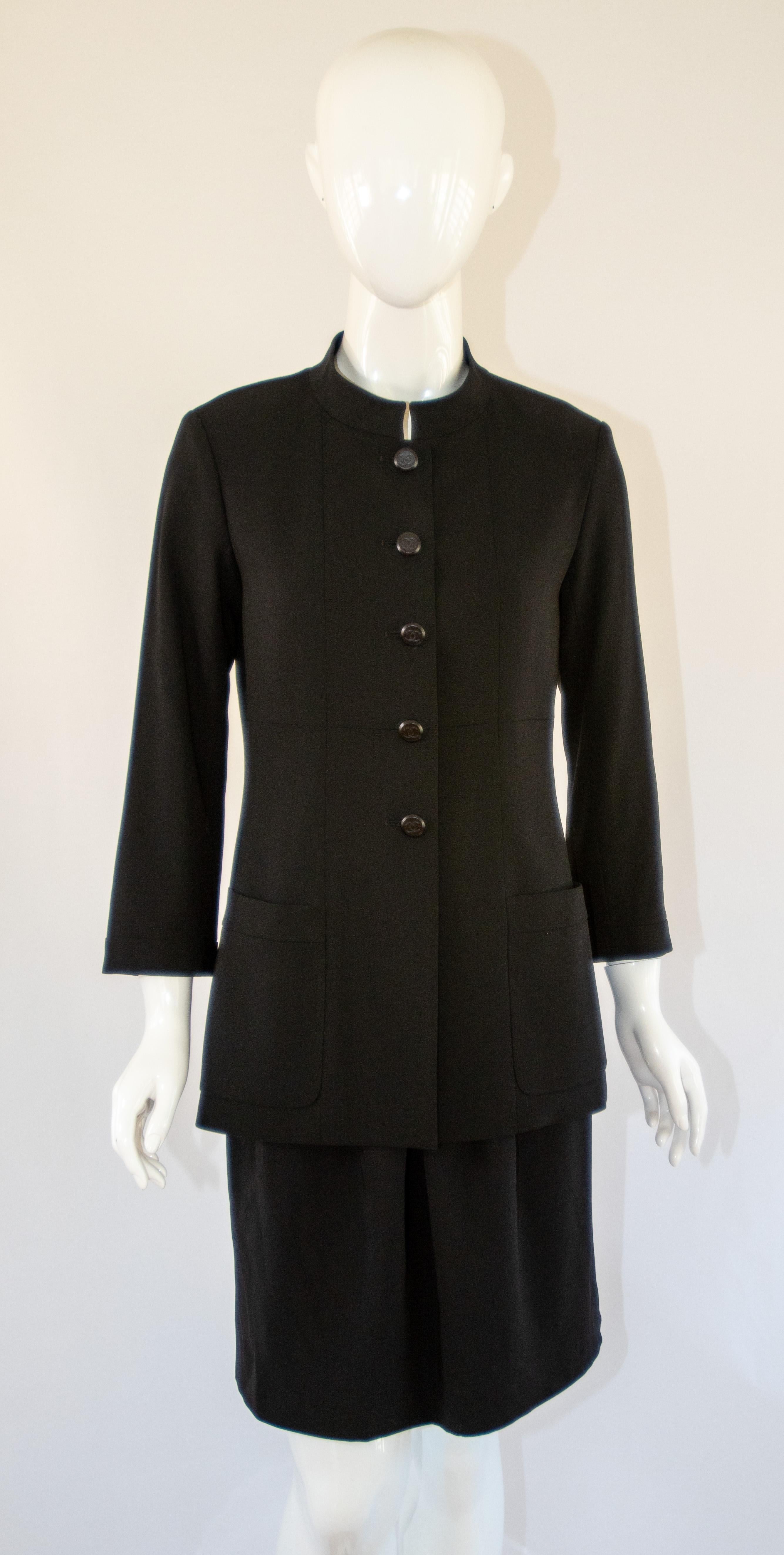 Vintage Chanel classic black blazer jacket 98A  from 1998 Fall Collection.
There are five front buttons and the 2 patch pockets on the front. 
Featuring a small unstructured collar and 3/4 length sleeves.
Buttons are shiny black plastic with the CC