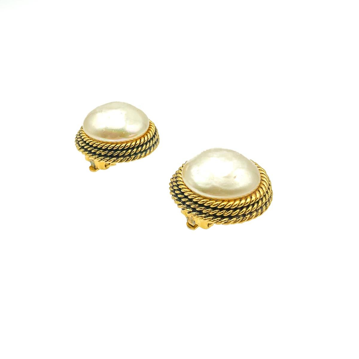 A divine pair of forever in style, totally classic, Vintage Chanel Pearl Earrings from 1984. Crafted in gold plated metal and set with a large poured glass pearl. In very good vintage condition without damage or wear - incredible condition given