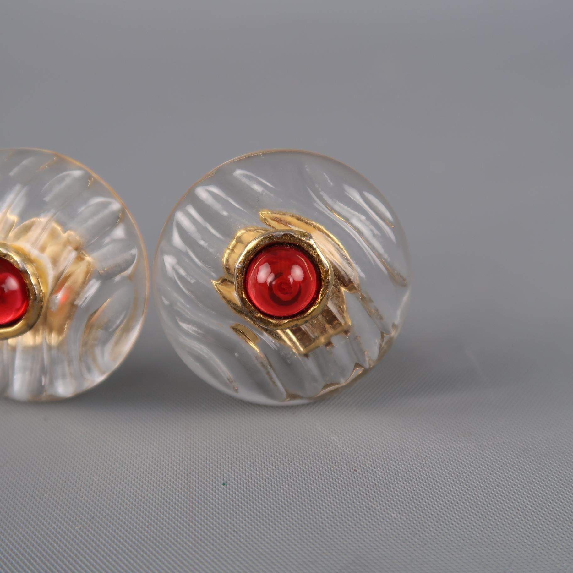 Vintage CHANEL clip on earrings feature round textured clear lucite bases adorned with a red faux gem stone encased with yellow gold tone metal boarder and clip on back. Minor wear. As-is. Made in France.
 
Vintage, Good Pre-Owned Condition.
 
1.25