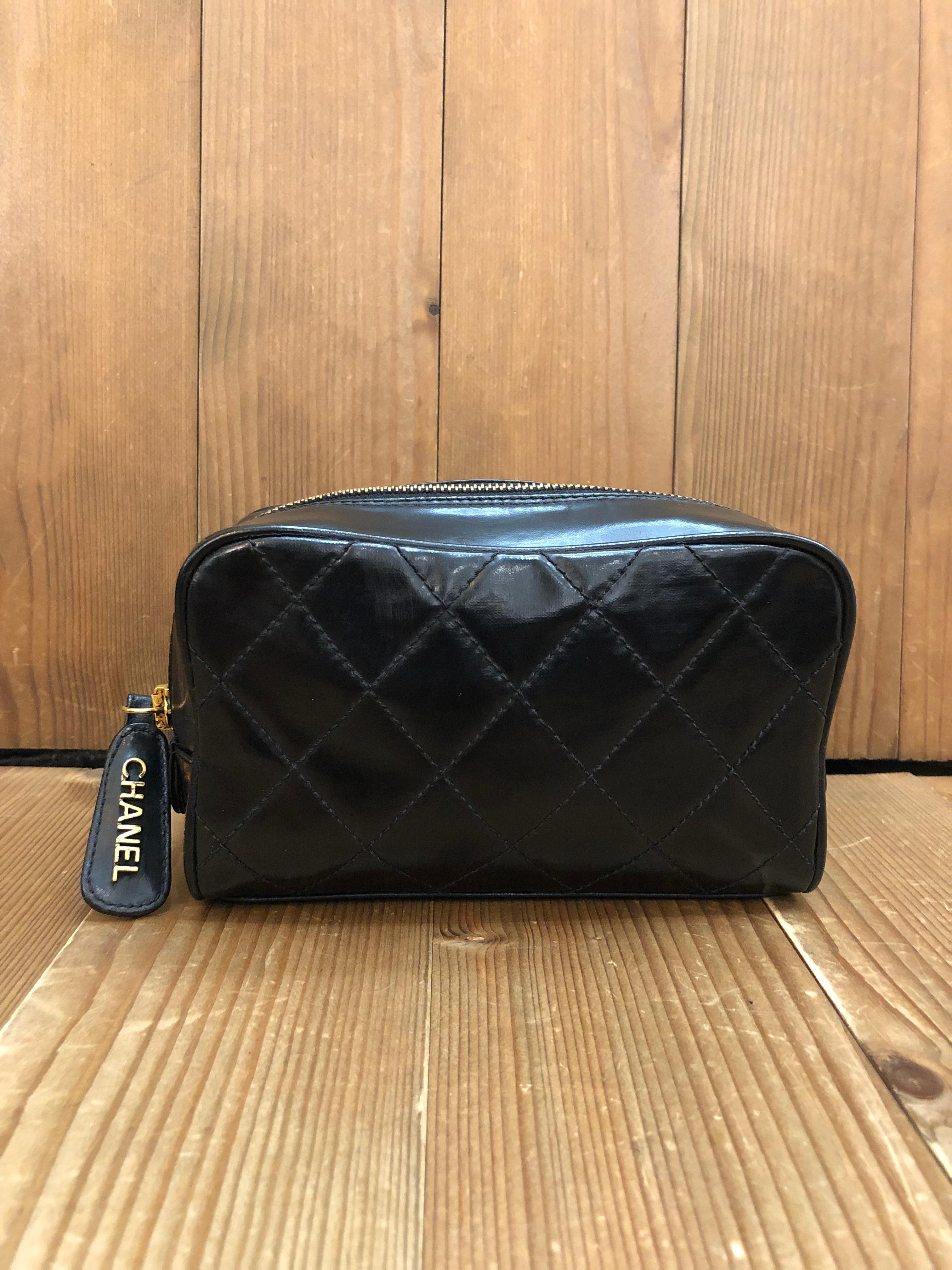 This vintage CHANEL vanity pouch clutch bag is crafted of black coated canvas in diamond quilted pattern. Top zipper closure opens to a black lambskin interior featuring two interior zippered pockets. Made in Italy 3xxxxxx series. Measures