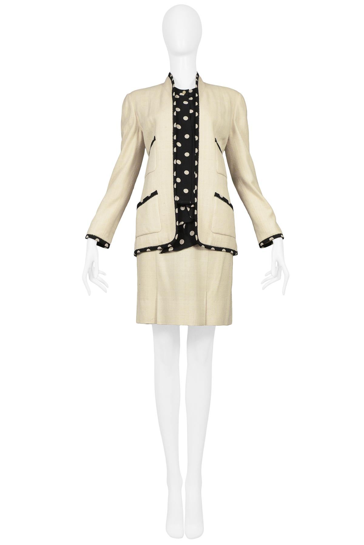 Vintage Chanel cream linen skirt suit. Open front suit jacket with front pockets trimmed in polka dot silk. Set includes matching box pleat skirt with silk polka dot fabric waist and coordinating silk blouse. This ensemble is a 3-piece