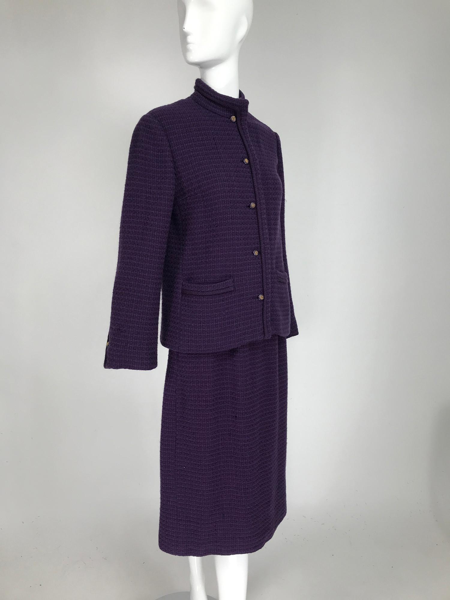 Vintage Chanel Creations purple wool skirt suit with purple & gold lion head buttons at the front & cuffs, gold chain hem in the lining. Mid weight waffle textured wool jacket, with band collar, princess seams, single button front, long sleeves have