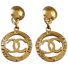 Vintage CHANEL Cutout Logo Medallion Hammered Dangling Earrings at 1stDibs