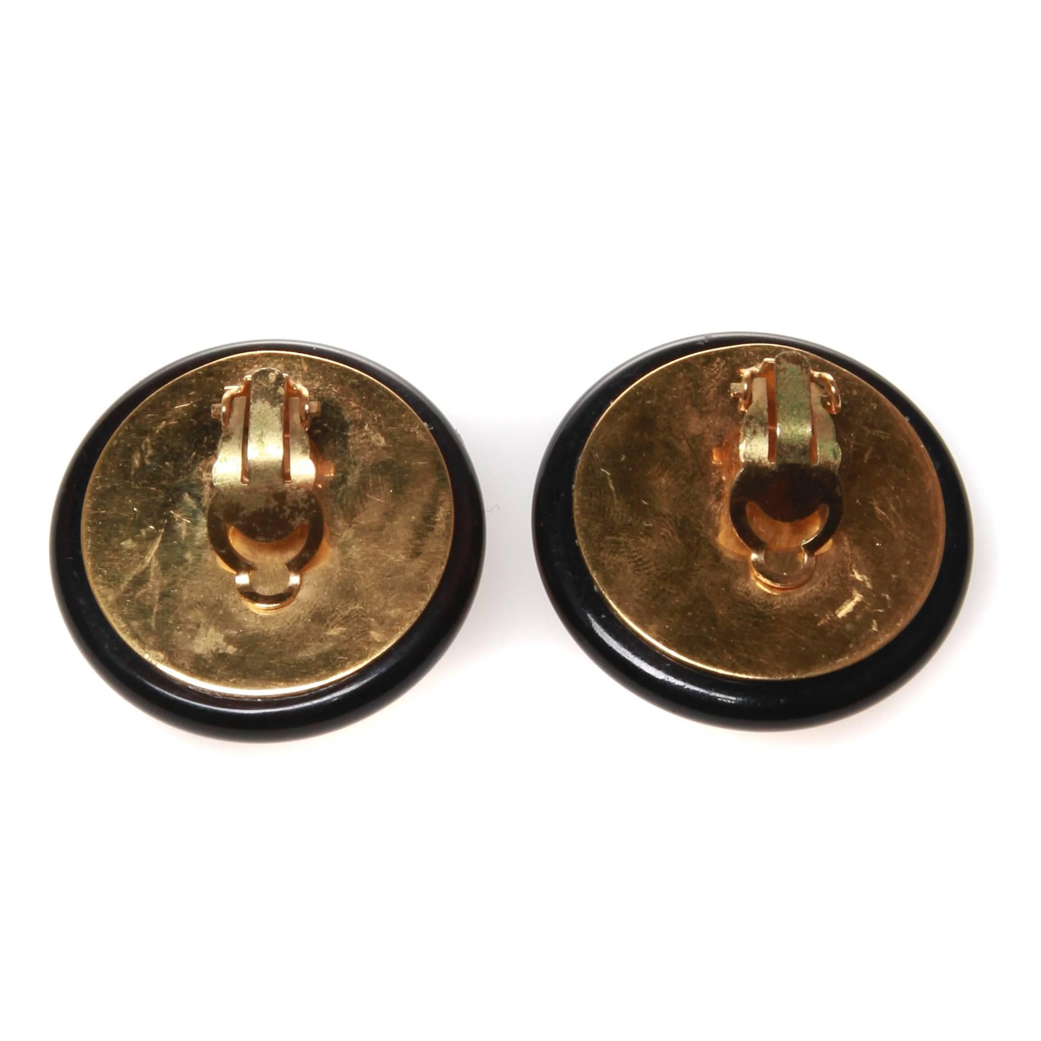 Vintage Chanel clip-on earrings featuring the interlocking CC against knit-look gold tone metal and black resin. 