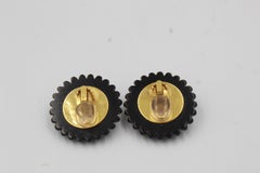 Vintage Chanel earrings with gold metal shell and black finishes.