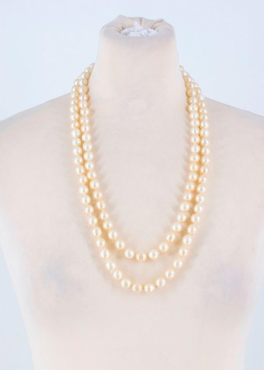Vintage Chanel Faux Pearl Necklace

- Long faux pearl necklace
- Image 5 shows true colour
- Features a small Chanel logo charm and a small plate
- Can be worn multiple ways
- Made in France

Please note, these items are pre-owned and may show signs