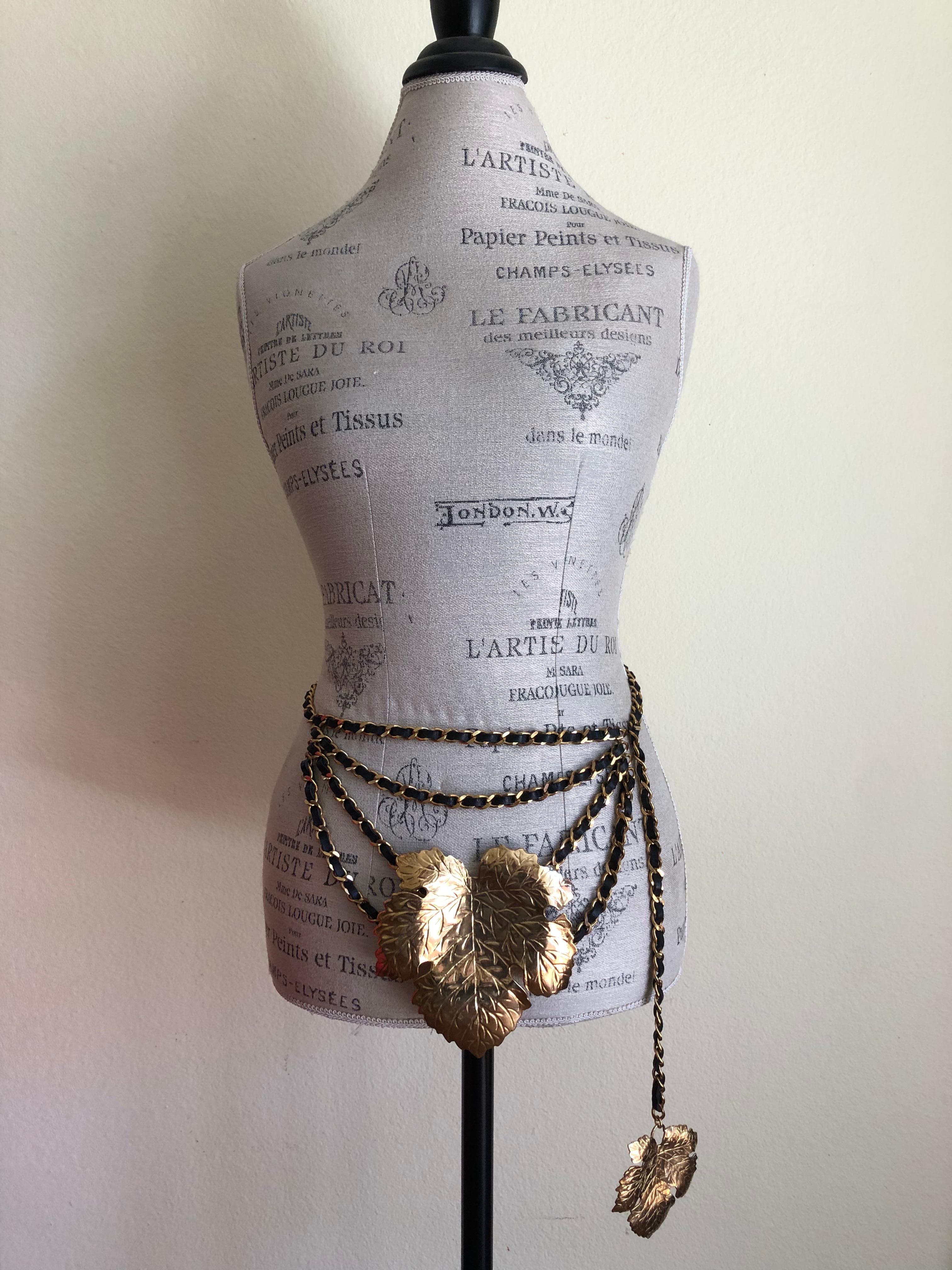 Vintage Chanel chain link fig leaf belt (circa 1991) designed by Karl Lagerfeld.  

Multiple layered leather chain belt adorned with two 24-karat gold plated fig leaves from Chanel's spring 1991 collection, designed by Karl Lagerfeld. The larger fig