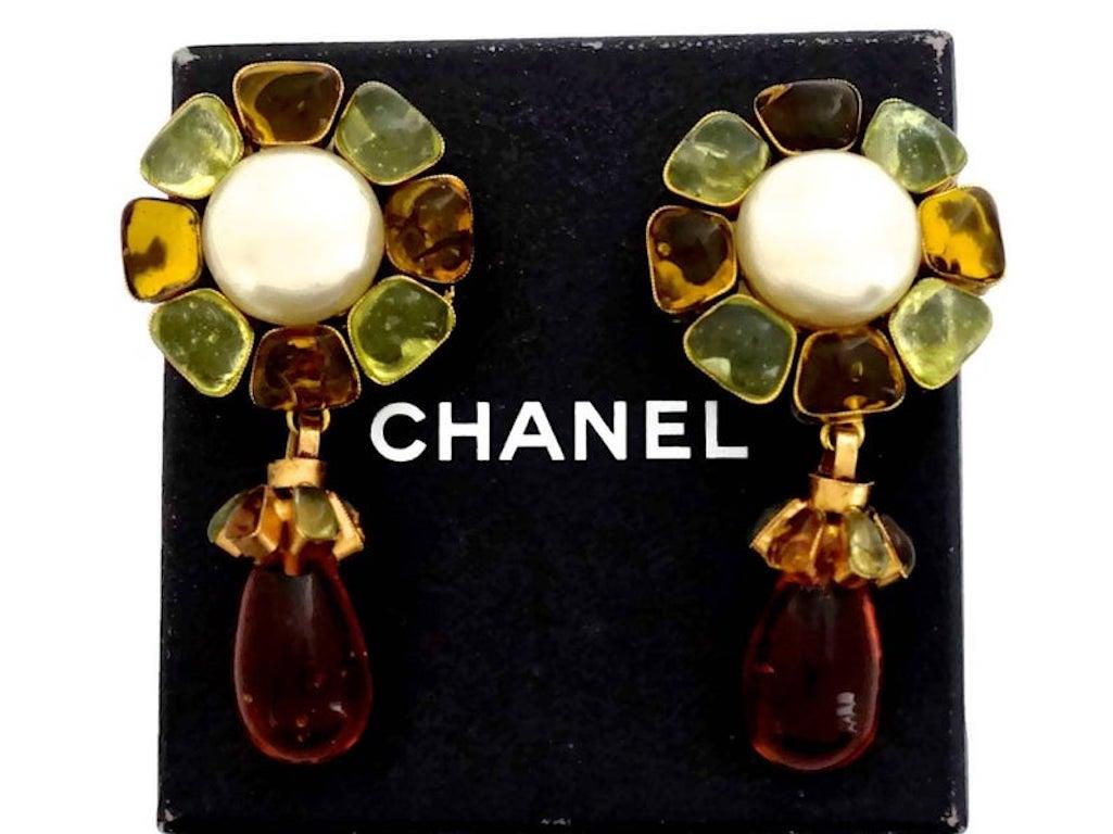 Vintage CHANEL Flower Pearl Gripoix Poured Glass Drop Earrings

Measurements:
Height: 2.75 inches (7 cm)
Width: 1.37 inches (3.5 cm)

Features:
- 100% authentic CHANEL.
- Gripoix/ Poured Glass flower drop earrings.
- Glass pearl at the centre.
-