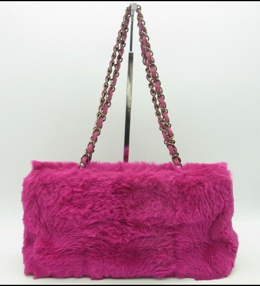Chanel pink Dyed rabbit fur shoulder bag/Clutch with Hot Pink dyed Leather and silvered chain. Pink Fur is soft to the touch. Pink Leather strap in in great condition. There is a gunmetal CC on the front of the bag between the fur and a silvered