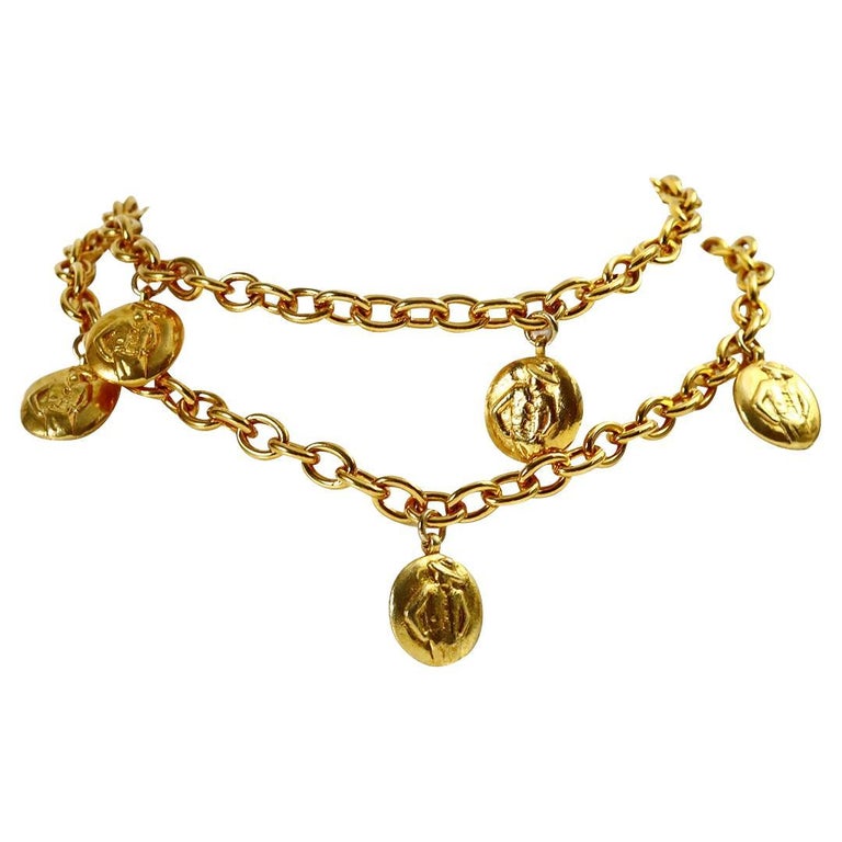 Vintage Chanel Gold Disc Chanel and Coco on Long Necklace. A great necklace from the 1980s with dangling discs that have an imprint of CoCo on one side and Chanel al over the other on a thick and heavy link chain in great shape.  Can be doubled and
