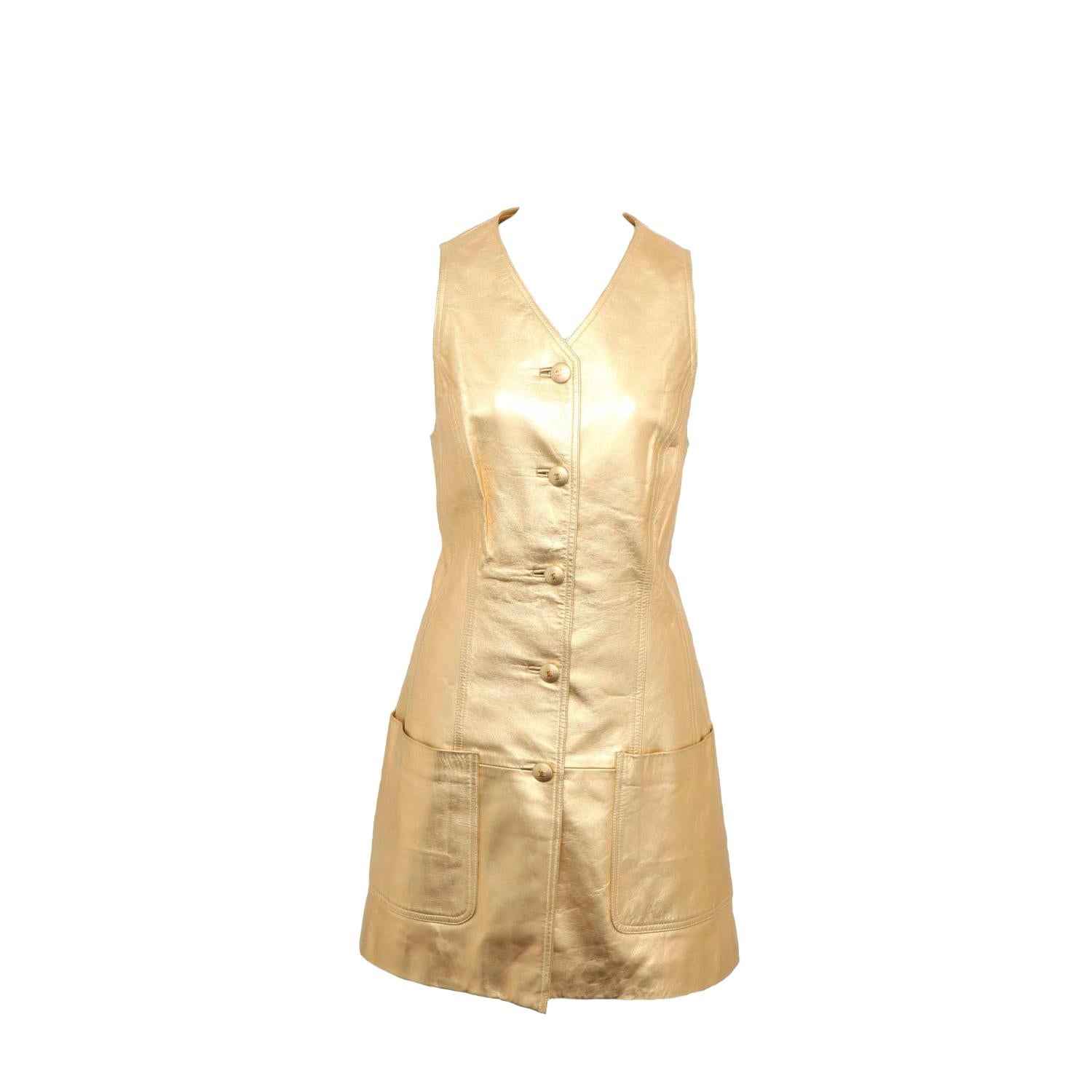 Extremely rare vintage Chanel Gold leather vest dress with CC Buttons. From the 1994 Fall/Winter collection. Belt sold separately.

Specifications: Size 40
Shoulders: 15 inches
Bust: 14.5 Inches
Waist: 16 Inches
Hip: 32 Inches