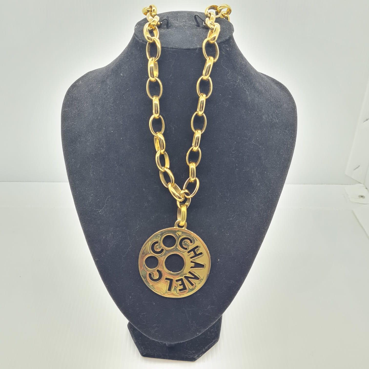 Women's or Men's Vintage Chanel Gold Logo Cut Out Pendant Necklace For Sale