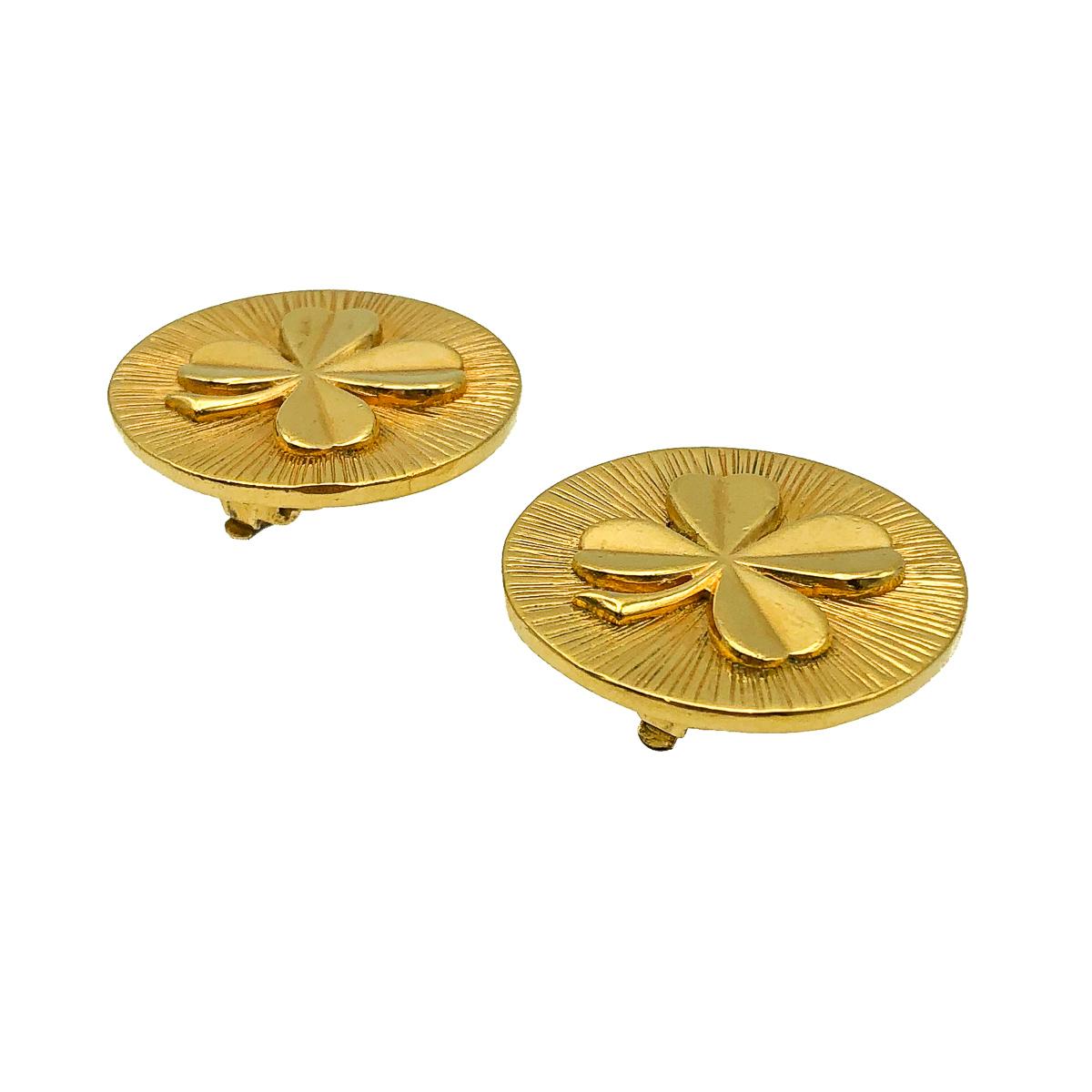 A magnificent, large disc style pair of Vintage Chanel Clover Earrings dating to the 1960s whilst Coco Chanel was at the helm of the House. Crafted in gold plated metal. Depicting exquisitely one of Gabrielle 'Coco' Chanel's lucky charms, the four