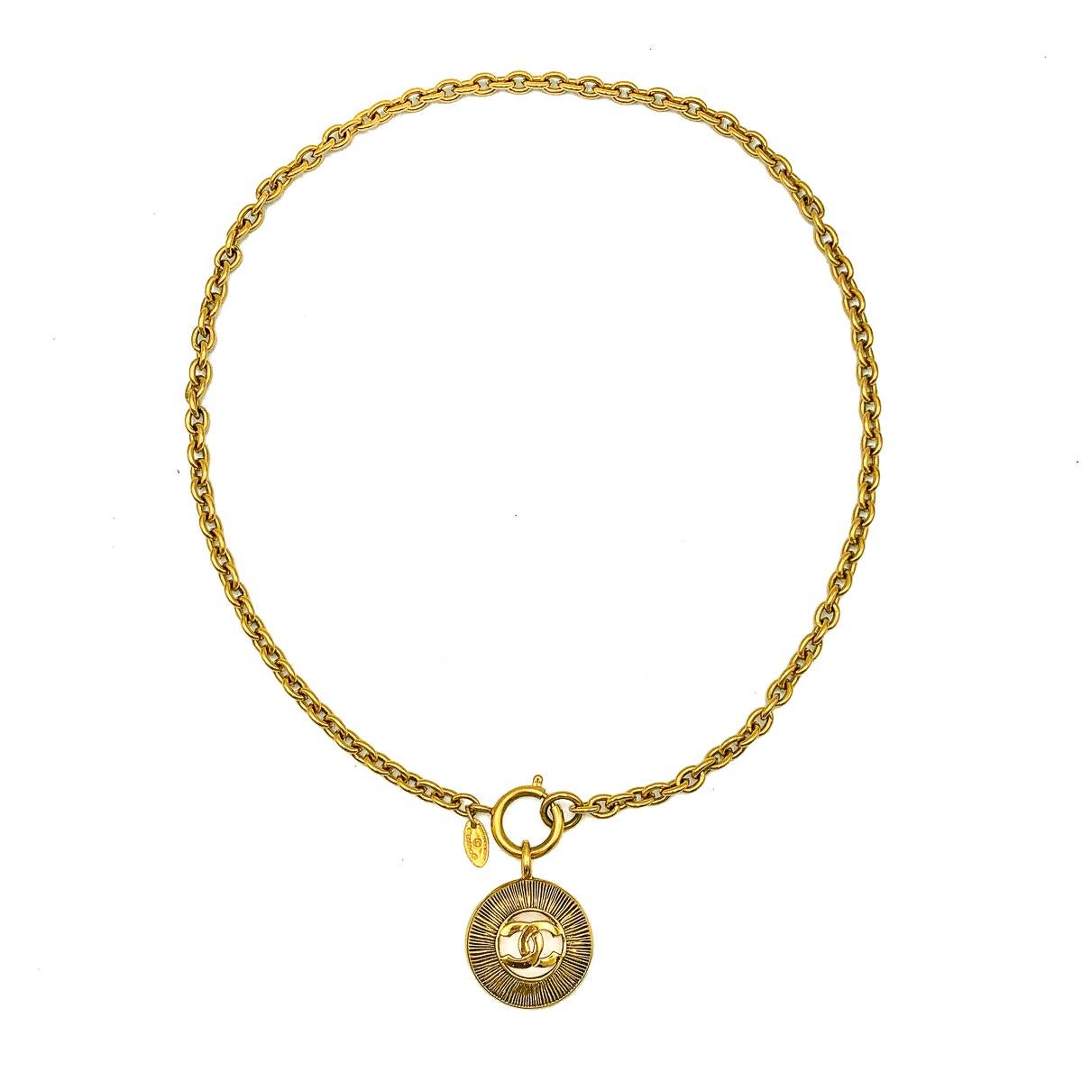 An utterly iconic Vintage Chanel Sunburst Necklace. Crafted in gold plated metal. In very good vintage condition. Signed. Approx. 58cms chain. A classically captivating piece from the House of Chanel that will prove eternally stylish. 

Established