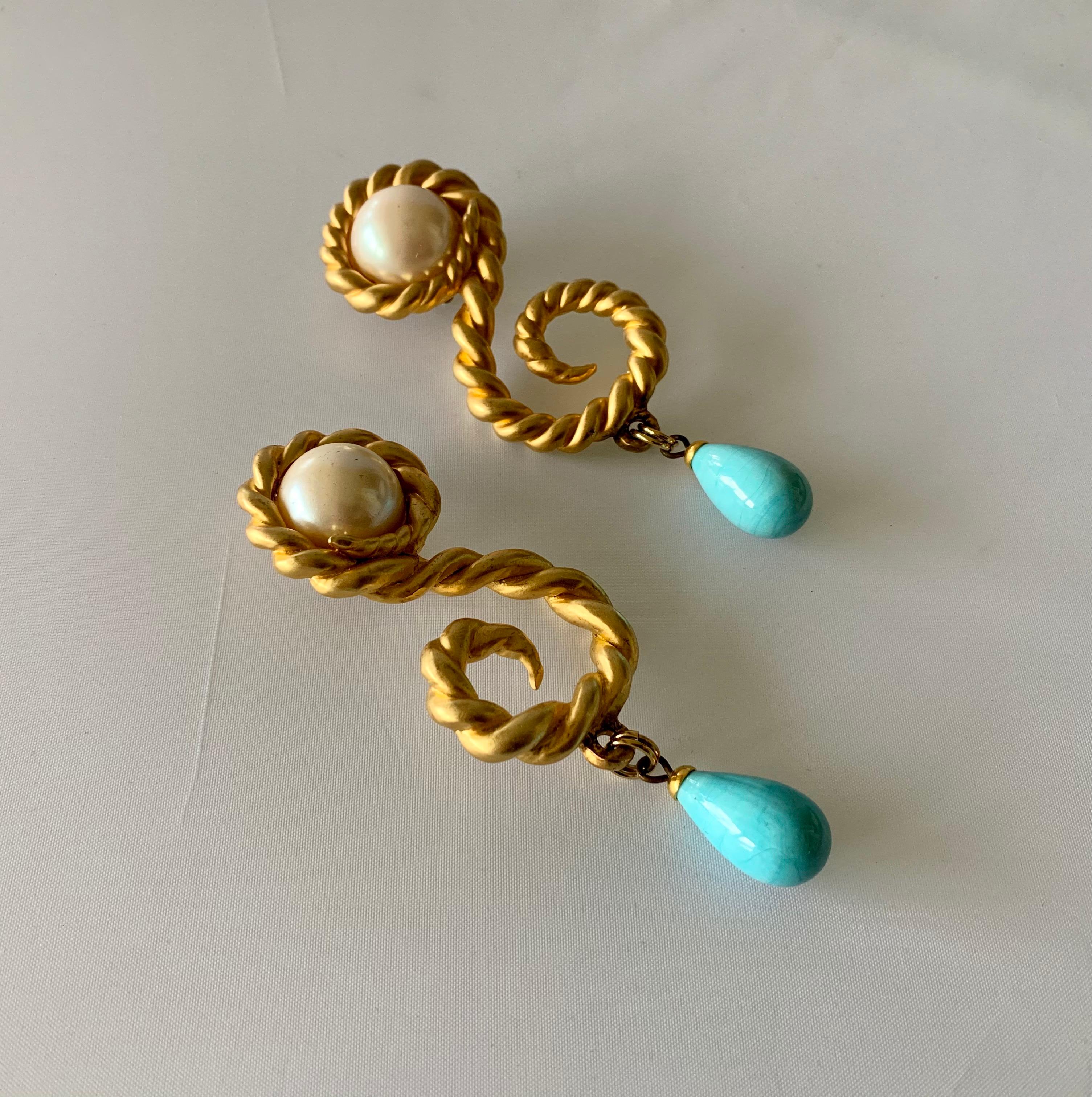Scarce large vintage Coco Chanel statement clip-on earrings, comprised out of satin gold metal in a swirl motif, the earrings feature large pearls at the center and large turquoise 