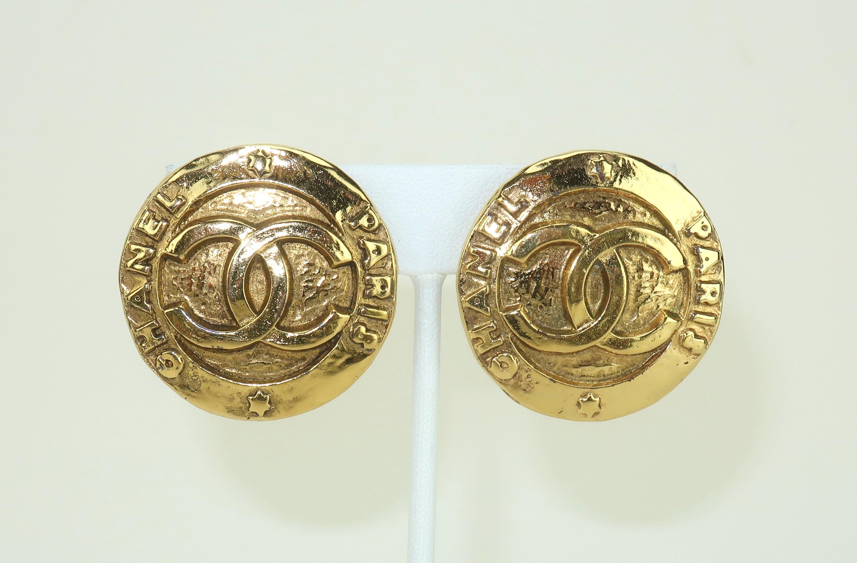 Classic Chanel gold plated logo earrings in a button style silhouette with opulent details.  The earring design is reminiscent of coins in keeping with one of Chanel's recurring themes.  The recognizable 'CC' logo is utilized in the design along