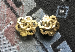 Vintage CHANEL gold tone star flower shape earrings with CC mark on top.