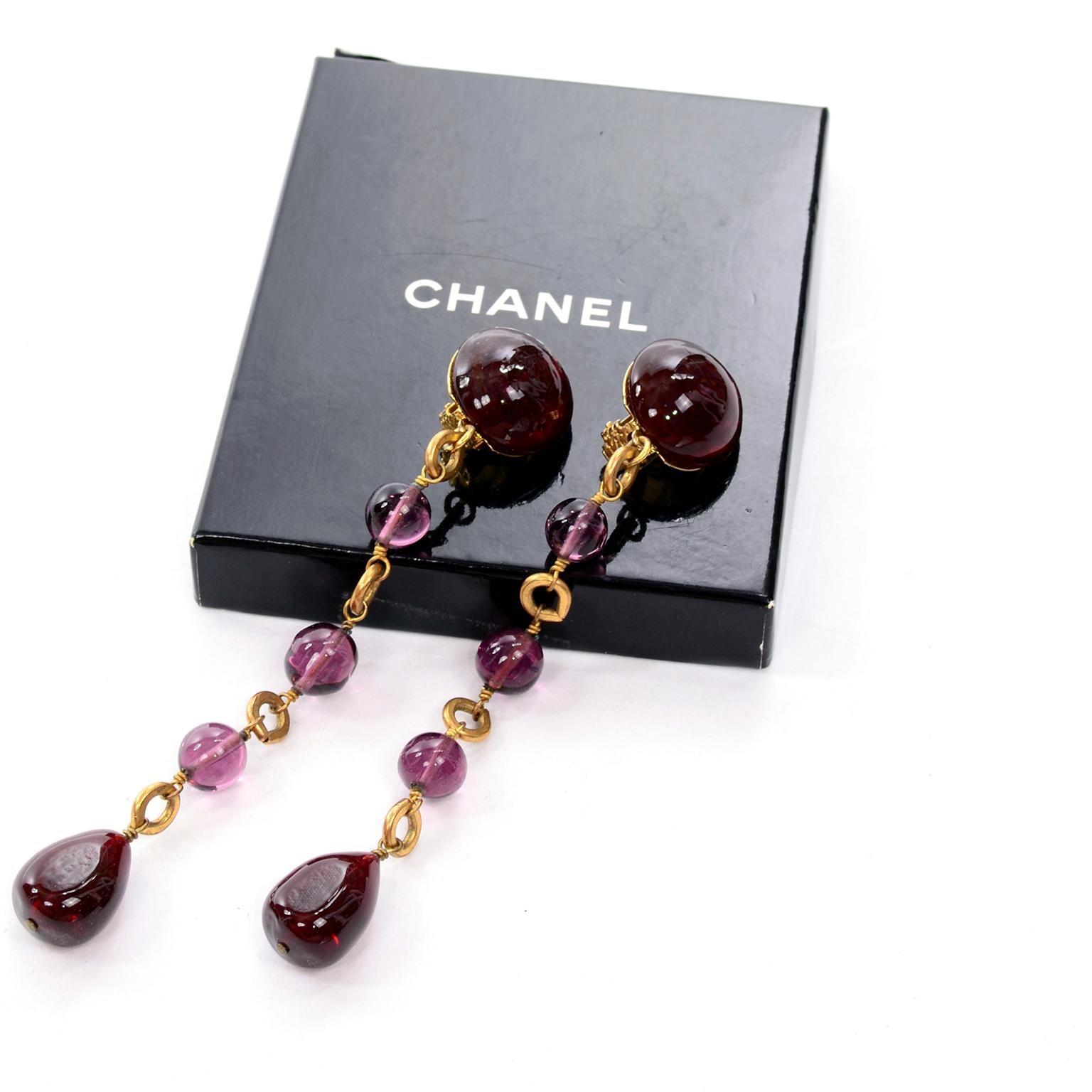 These are stunning vintage late 1980's or early 1990's Chanel clip earrings with purple gripoix stones on gold metal.  Marked Chanel made in France, these were designed during the years that Victoire de Castellane was overseeing the costume jewelry