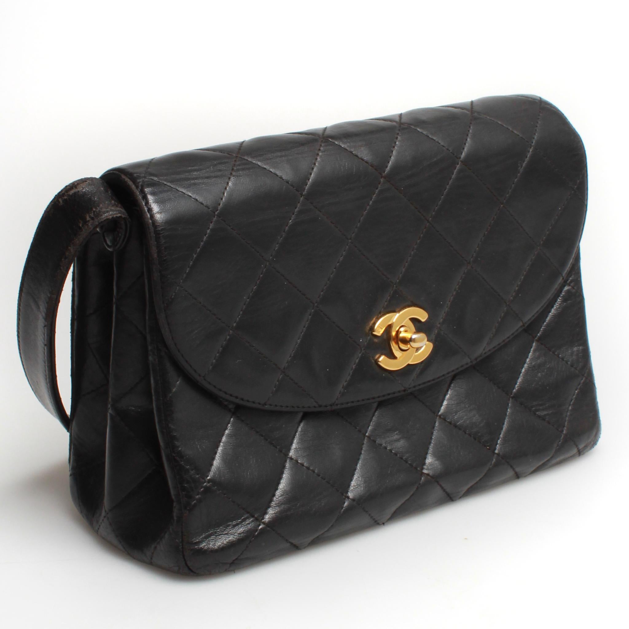Vintage CHANEL black quilted lamskin flap handbag with gold toned hardware, interior zip pocket for valuables and two main leather interior compartments. 