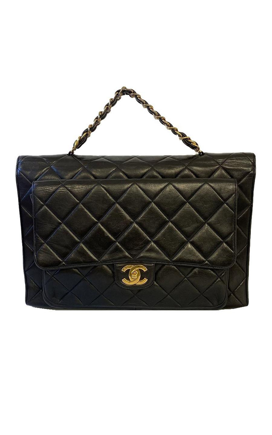 Chanel handbag with gold-colored hardware. The material of the bag is black Lambskin Leather. The bag opens with the interlocking CC lock. There are two compartments and two small pockets on the inside of the bag, one with a zipper and one slip in.