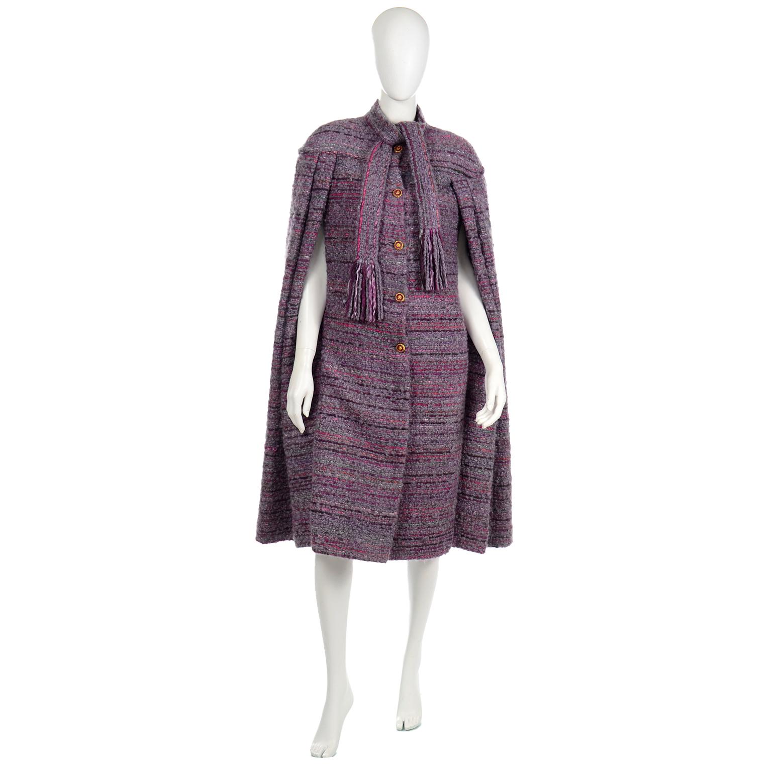 This is a very rare vintage Chanel Haute Couture wool boucle cape coat from the 1980's in a variety of shades of purple. This cape has pleating along the front and back, giving it a lot of volume in the body from the bust down. The arm opening is