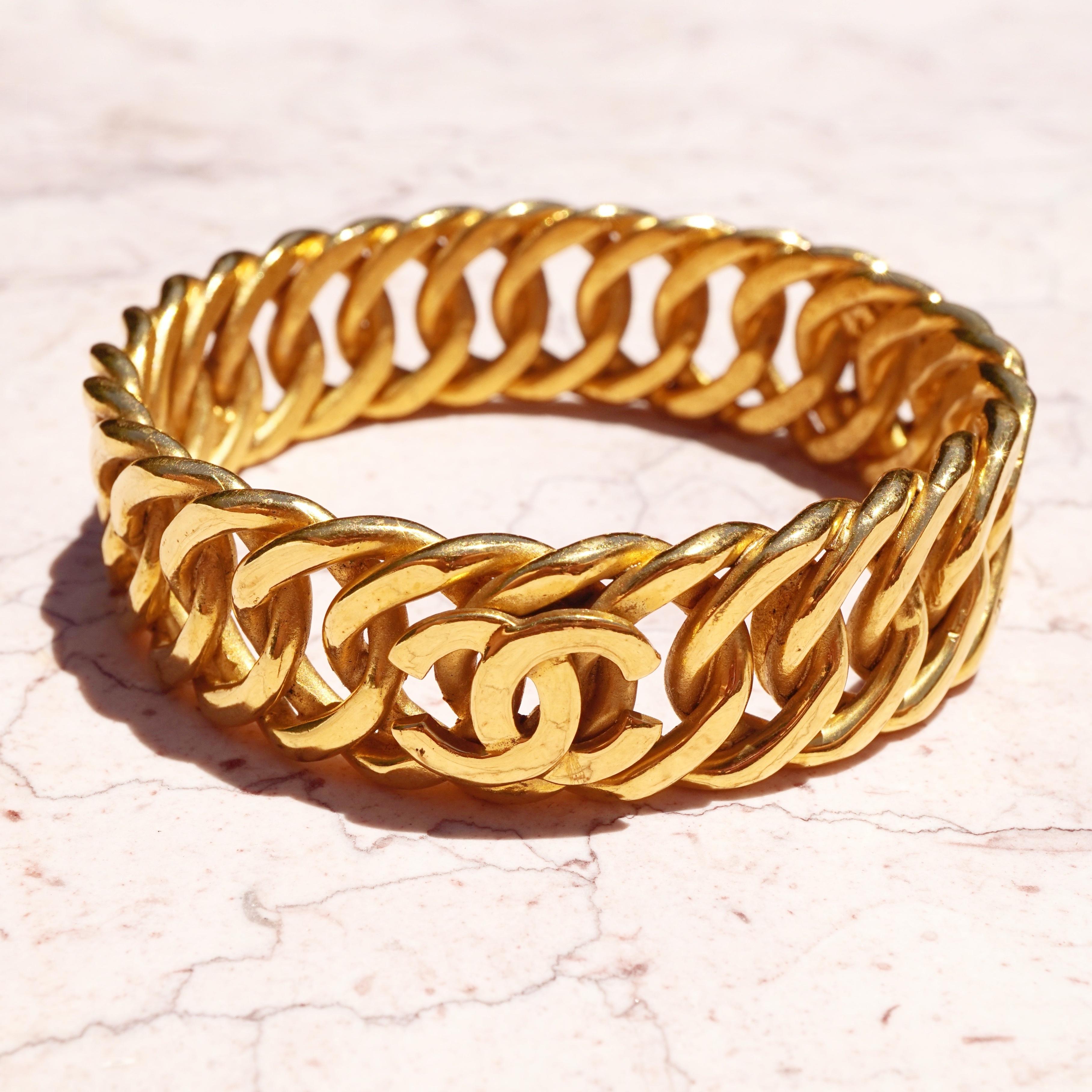 Vintage, signed Chanel heavy gilt curb chain bangle bracelet decorated with three Chanel 
