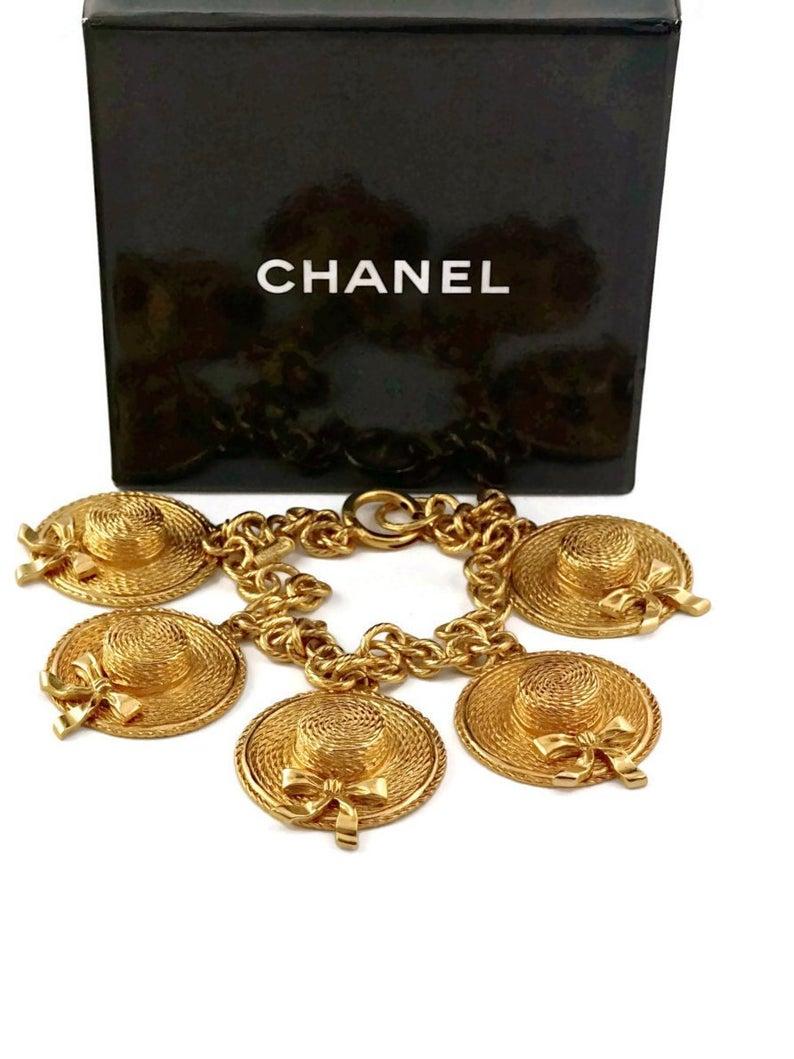 Vintage CHANEL Iconic Sun Hat Charm  Necklace

Measurements:
Height: 1 6/8 inches (4.44 cms)
Width: 1 5/8 inches (4.12 cms)
Wearable Length: 15 1/8 inches (38.41 cms)

Features:
- 100% Authentic CHANEL.
- 5 iconic Chanel sun hat charms.
- Chunky