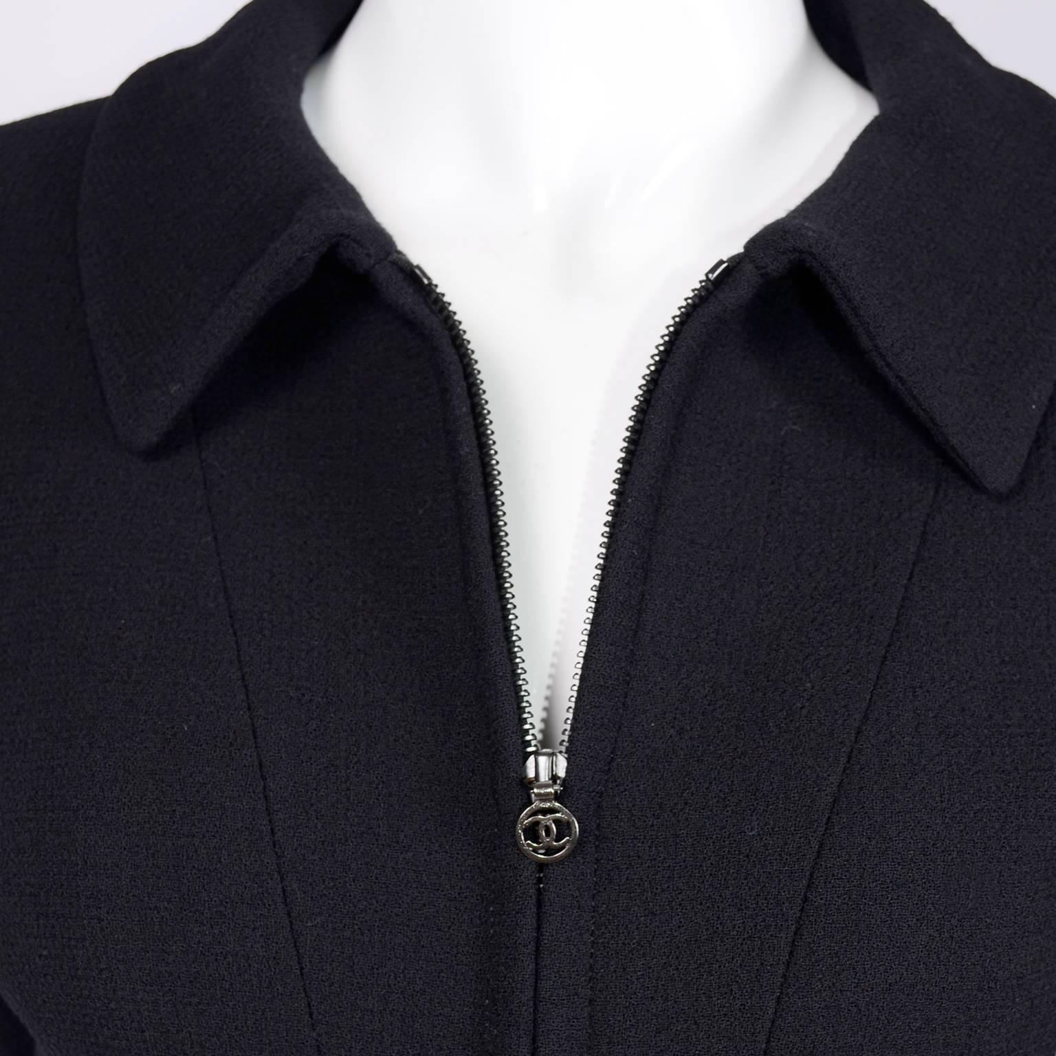 This Chanel jacket has a zipper that runs 3/4 the way down the jacket and has visible decorative seam lines on the front. We tried to lighten one of the photos to show the details! Lined in silk CC logo lining, this blazer is from Chanel’s 1997