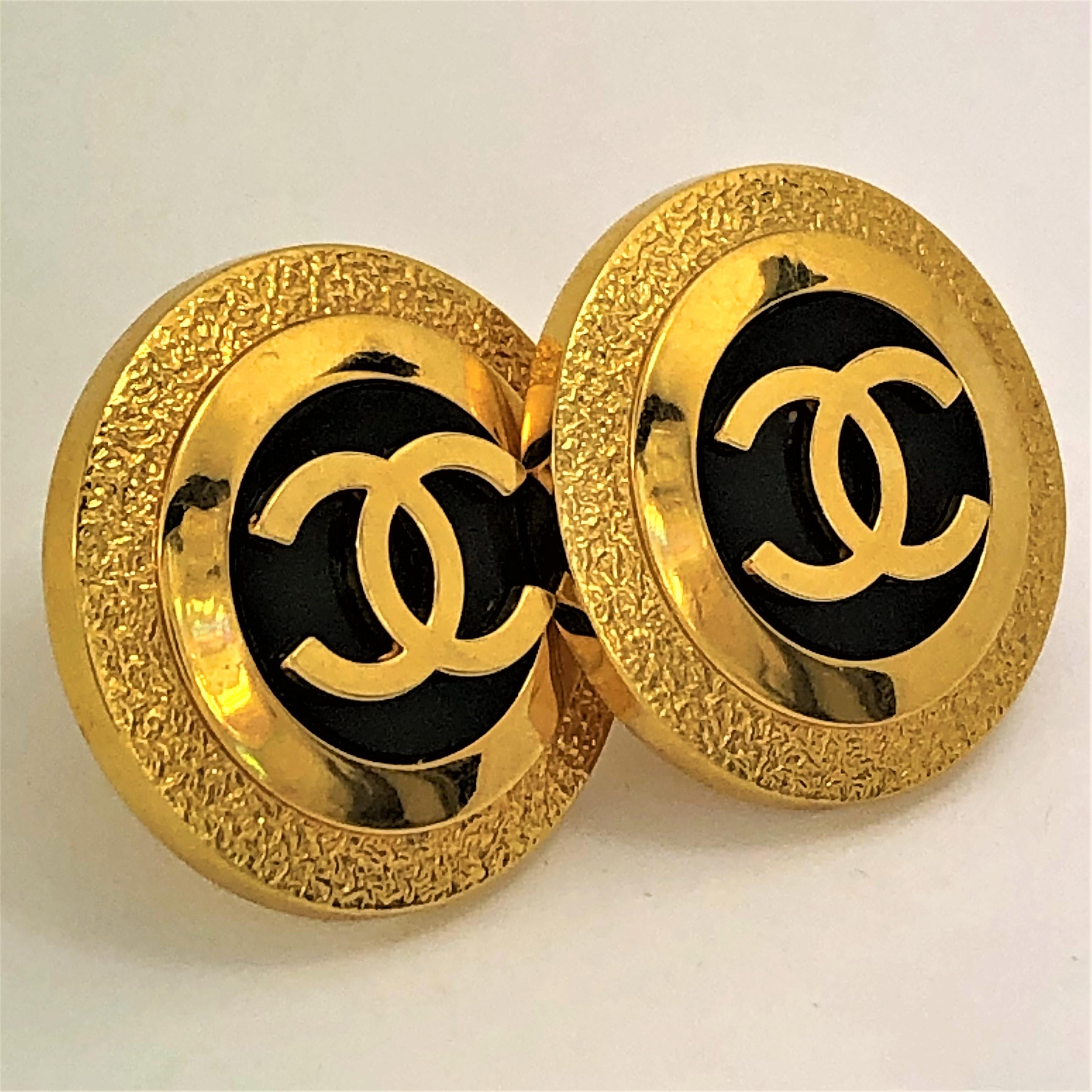 Large size ( 1.5 Inch diameter ) Vintage Gold Tone Chanel earrings with black resin
centers accented by large CC logos. Elegant for day or night use. Comfortable clip on 
backs with silicon pads. From the 1993 Spring collection. Marked Chanel 93 CC