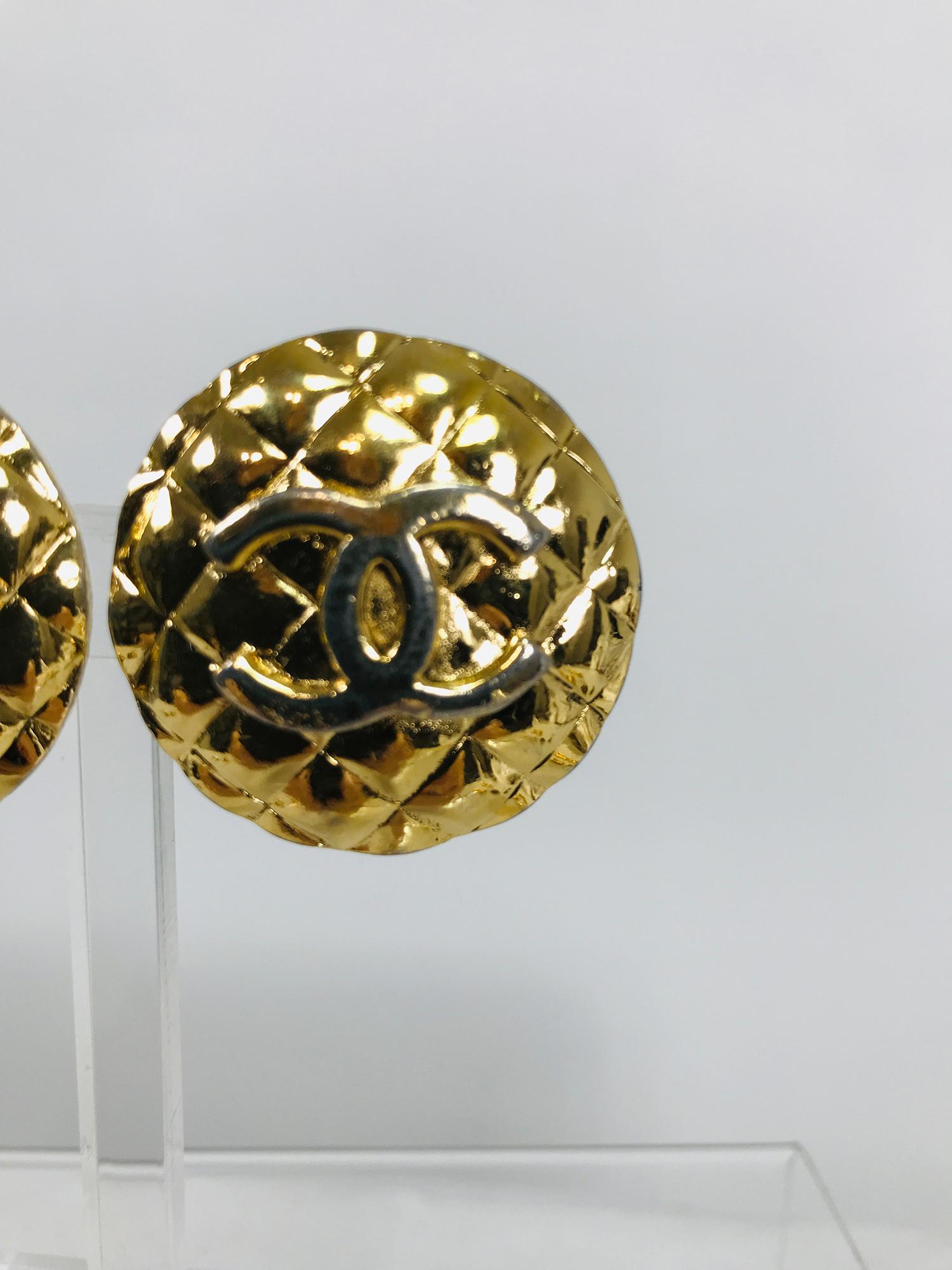 Vintage Chanel large round goldtone quilted raised logo clip back earrings from the 1960s. Beautiful earrings are simply marked Chanel in capital letters on the back bar of each earring. Each measures 1 1/2